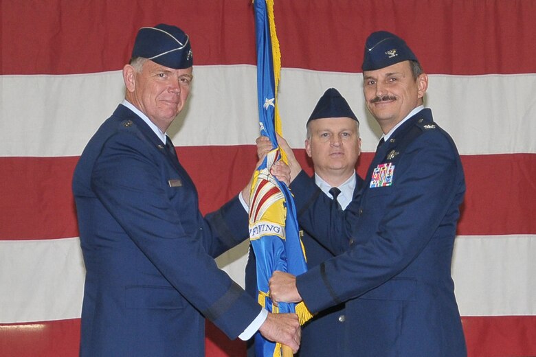 YOUNGSTOWN AIR RESERVE STATION, Ohio -- Maj. Gen. Wallace T. Ferris Jr. passes the 910th Airlift Wing guidon to Col. Reinhardt Schmidt at a change of command ceremony held here, Nov. 5, 2011. Col. Schmidt, whose last assignment was at Air Force Reserve Command, Robins Air Force base, Ga, succeeds outgoing commander, Col. Stephen J. "Fritz" Linsenmeyer Jr.. U.S. Air Force photo by Tech. Sgt. James L. Brock