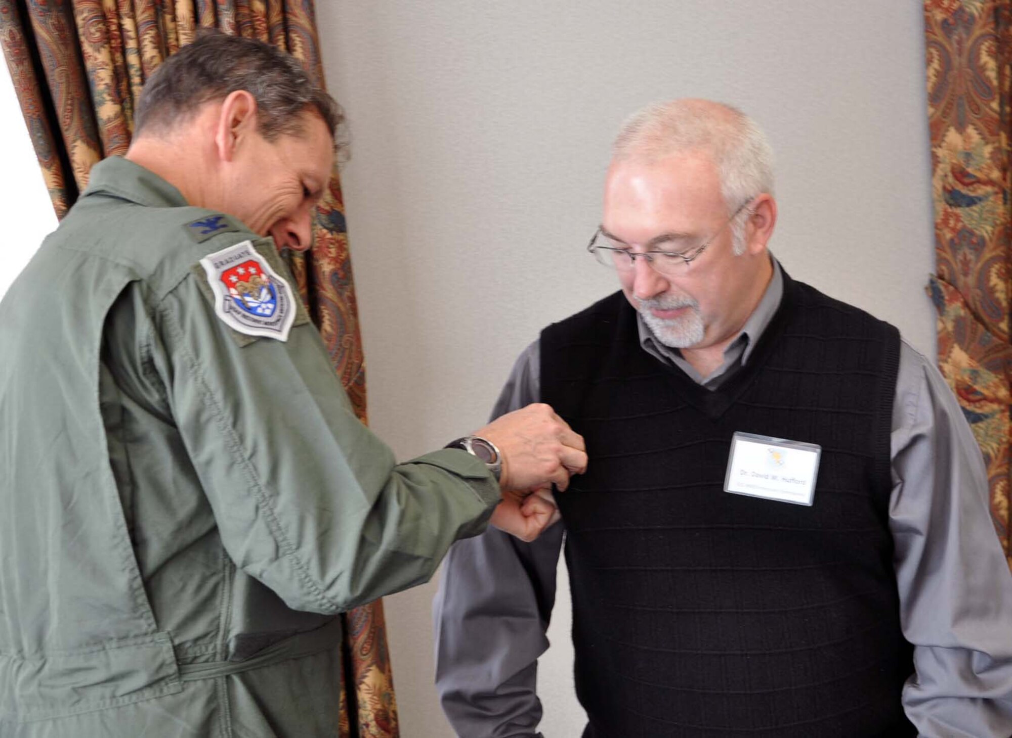 Col. Evan Kapp, commander of the 931st Aeromedical Squadron, presents a commander's insignia pen his honorary commander, Dr. David Hufford, during an honorary commander's luncheon in downtown Wichita, Kan., Nov. 5, 2011.  Following the luncheon, honorary commanders were invited to visit the 931st headquarters at McConnell Air Force Base for a mission brief and to visit with 931st Airmen.  The purpose of the honorary commander program is to develop strong ties between the leaders of the 931st and the leaders of local communities.  (U.S. Air Force photo by Tech. Sgt. Brannen Parrish)
