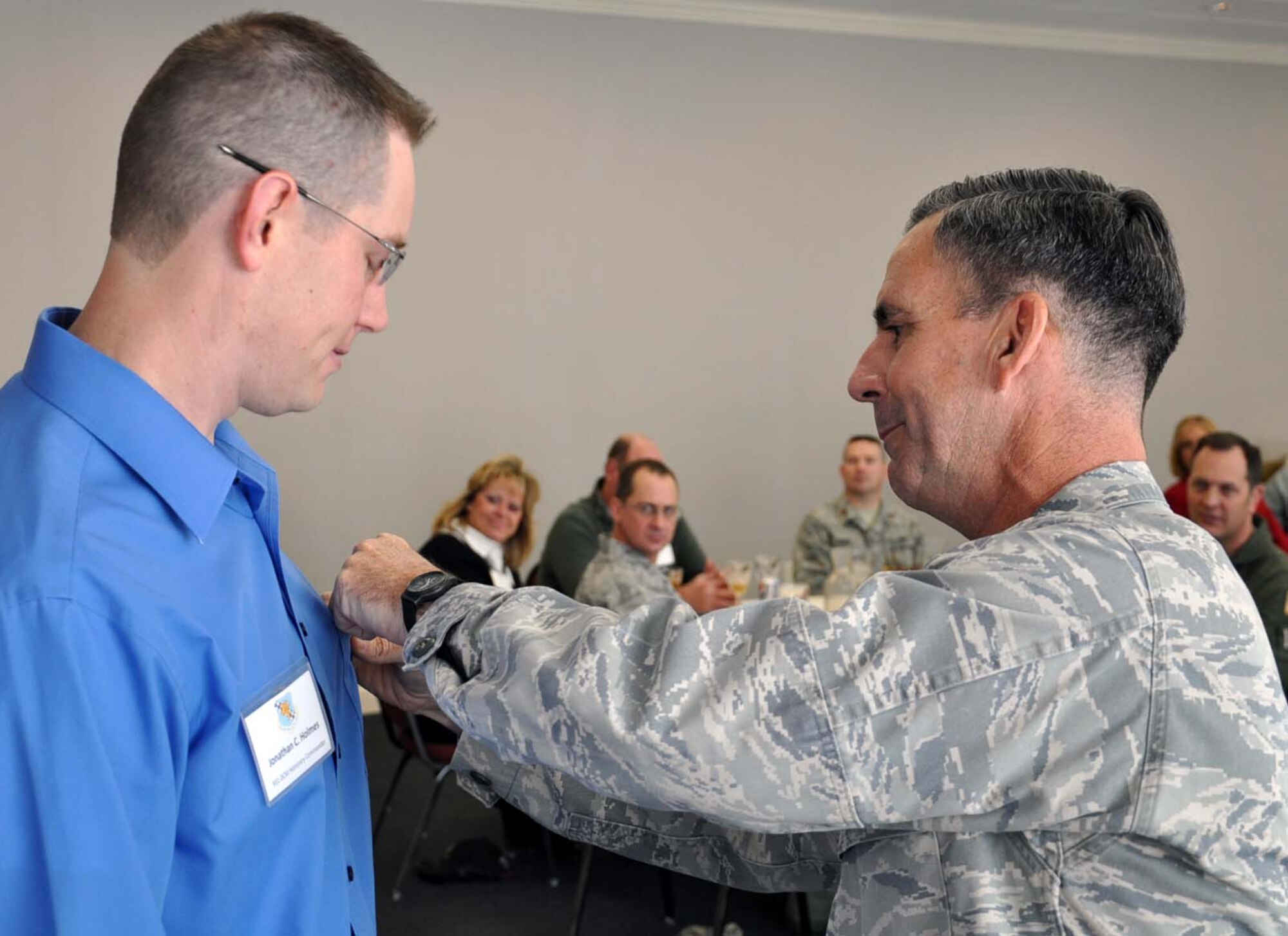 Lt. Col. Donald Robison, 931st Air Refueling Group Deputy Commander of Maintenance, presents a commander's insignia pen his honorary commander, Jon Holmes, during an honorary commander's luncheon in downtown Wichita, Kan., Nov. 5, 2011.  Following the luncheon, honorary commanders were invited to visit the 931st headquarters at McConnell Air Force Base for a mission brief and to visit with 931st Airmen.  The purpose of the honorary commander program is to develop strong ties between the leaders of the 931st and the leaders of local communities.  (U.S. Air Force photo by Tech. Sgt. Brannen Parrish)