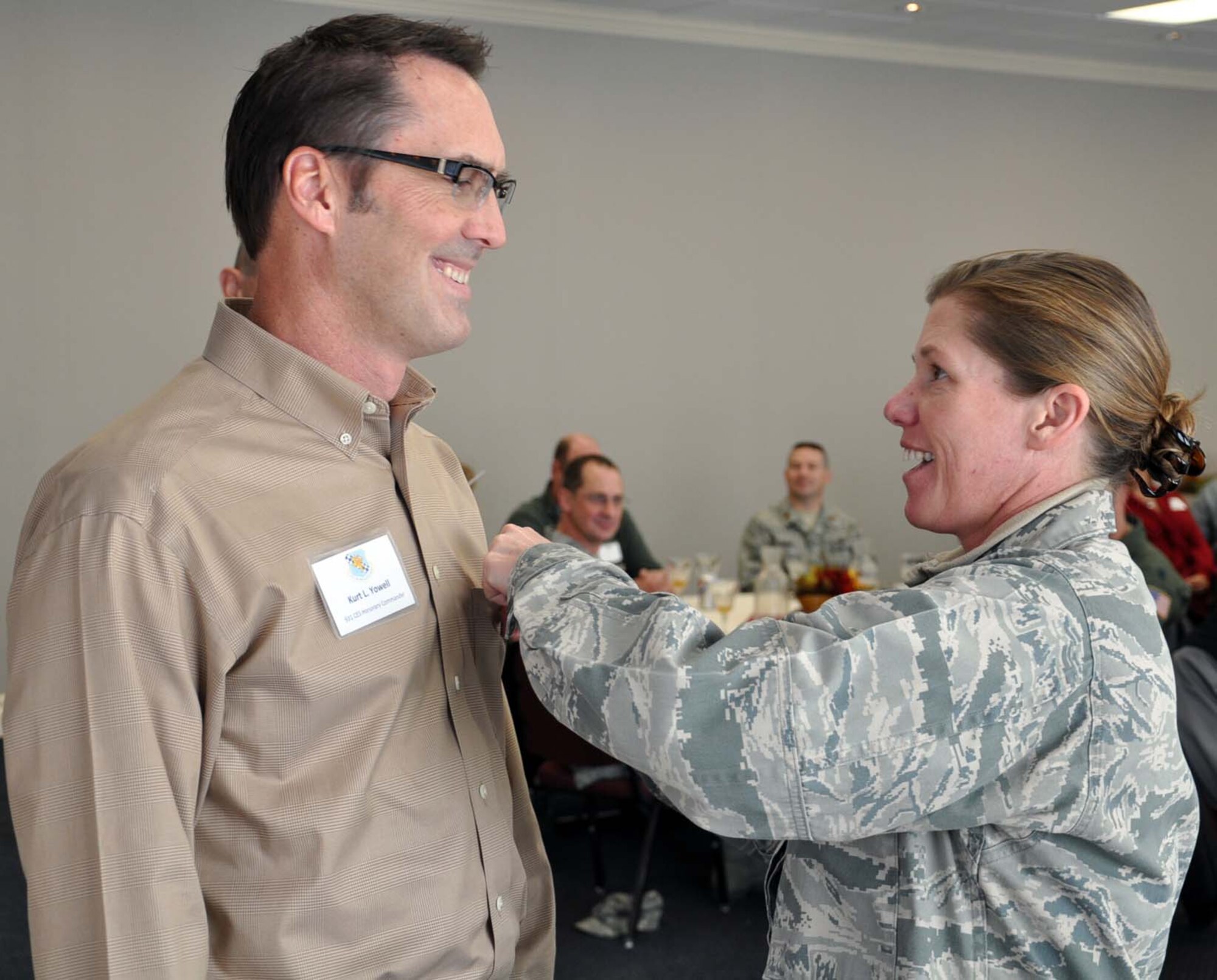Lt. Col. Erin Manning, commander of the 931st Civil Engineer Squadron, presents a commander's insignia pin to Kurt Yowell, honorary commander of the 931st CES, during an honorary commander's luncheon in downtown Wichita, Nov. 5, 2011.  Following the luncheon, honorary commanders were invited to visit the 931st headquarters at McConnell Air Force Base for a mission brief and to visit with 931st Airmen.  The purpose of the honorary commander program is to develop strong ties between the leaders of the 931st and the leaders of local communities.  (U.S. Air Force photo by Tech. Sgt. Brannen Parrish)