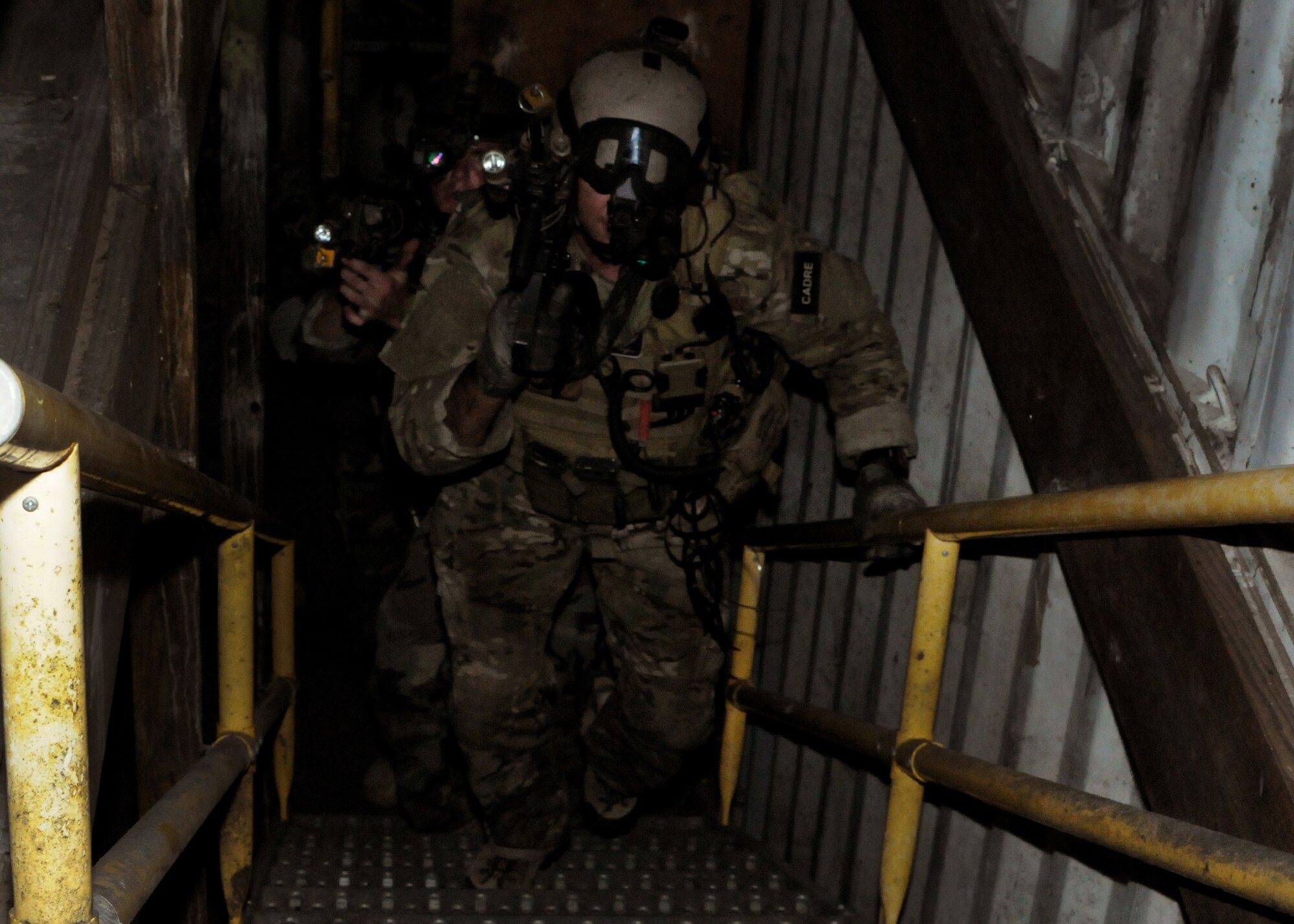 Students with the 23rd Special Tactics Training Squadron move upstairs to clear a building during a recent two-day exercise at Duke Field Fla. Hurlburt Field Airmen were dropped to the exercise location by a 919th Special Operations Wing MC-130E Combat Talon I to begin the exercise.  The exercise provided counter-insurgency tactics, land navigation and mission planning to potential Air Force combat controllers.  (U.S. Air Force photo/Tech. Sgt. Cheryl Foster)