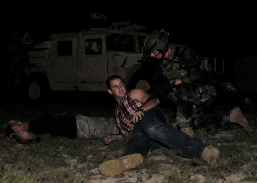 A 23rd Special Tactics Training Squadron student questions a suspected insurgent during a recent two-day exercise at Duke Field Fla.  Hurlburt Field Airmen were dropped to the exercise location by a 919th Special Operations Wing MC-130E Combat Talon I to begin the exercise.  The exercise provided counter-insurgency tactics, land navigation and mission planning to potential Air Force combat controllers.  (U.S. Air Force photo/Tech. Sgt. Cheryl Foster)