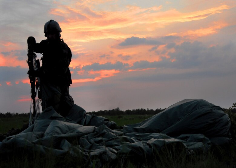 A 23rd Special Tactics Training Squadron student untangles his parachute after a jump from a MC-130E Combat Talon I during a recent two-day exercise at Duke Field Fla.  The aircrew of reservists delivered approximately six Hurlburt Field Airmen and their equipment to their coordinates to begin the exercise.  The exercise provided counter-insurgency tactics, land navigation and mission planning to potential Air Force combat controllers.  (U.S. Air Force photo/Tech. Sgt. Cheryl Foster)