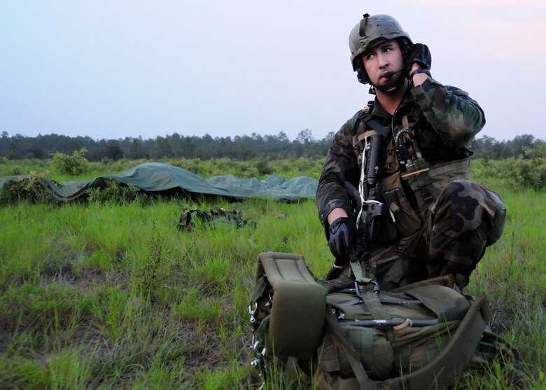 A 23rd Special Tactics Training Squadron student communicates with other students after parachuting out of a MC-130E Combat Talon I during a recent two-day exercise at Duke Field Fla.  The aircrew of reservists delivered approximately six Hurlburt Field Airmen and their equipment to their coordinates to begin the exercise.  The exercise provided counter-insurgency tactics, land navigation and mission planning to potential Air Force combat controllers.  (U.S. Air Force photo/Tech. Sgt. Cheryl Foster)