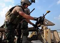 A student with the 23rd Special Tactics Training Squadron, prepares his weapons on a Humvee before it's loaded on to a MC-130E Combat Talon during a recent mission as part of a two-day exercise at Duke Field, Fla.  The aircrew of reservists delivered approximately six Hurlburt Field Airmen and their equipment to their coordinates to begin the exercise.  The exercise provided counter-insurgency tactics, land navigation and mission planning to potential Air Force combat controllers.  (U.S. Air Force photo/Tech. Sgt. Cheryl Foster)