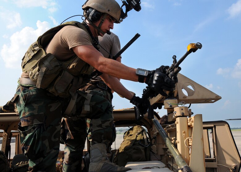 A student with the 23rd Special Tactics Training Squadron, prepares his weapons on a Humvee before it's loaded on to a MC-130E Combat Talon during a recent mission as part of a two-day exercise at Duke Field, Fla.  The aircrew of reservists delivered approximately six Hurlburt Field Airmen and their equipment to their coordinates to begin the exercise.  The exercise provided counter-insurgency tactics, land navigation and mission planning to potential Air Force combat controllers.  (U.S. Air Force photo/Tech. Sgt. Cheryl Foster)
