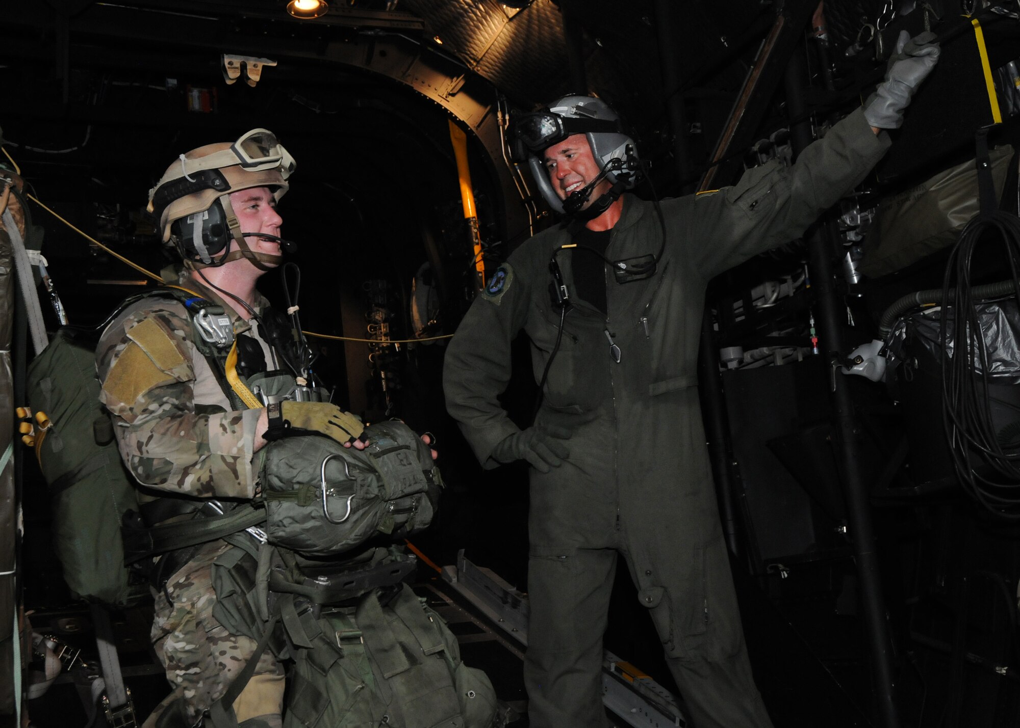 A student with the 23rd Special Tactics Training Squadron, talks with a 711th Special Operations Squadron loadmaster during a recent jump mission as part of a two-day exercise at Duke Field, Fla.  The aircrew of reservists delivered approximately six Hurlburt Field Airmen and their equipment to their coordinates to begin the exercise.  The exercise provided counter-insurgency tactics, land navigation and mission planning to potential Air Force combat controllers.  (U.S. Air Force photo/Tech. Sgt. Cheryl Foster)