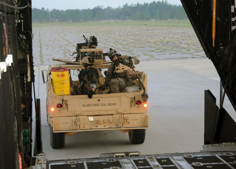 Students with the 23rd Special Tactics Training Squadron, roll their Humvee out of a MC-130E Combat Talon during a recent mission as part of a two-day exercise at Duke Field, Fla.  The aircrew of reservists delivered approximately six Hurlburt Field Airmen and their equipment to their coordinates to begin the exercise.  The exercise provided counter-insurgency tactics, land navigation and mission planning to potential Air Force combat controllers.  (U.S. Air Force photo/Tech. Sgt. Cheryl Foster)
