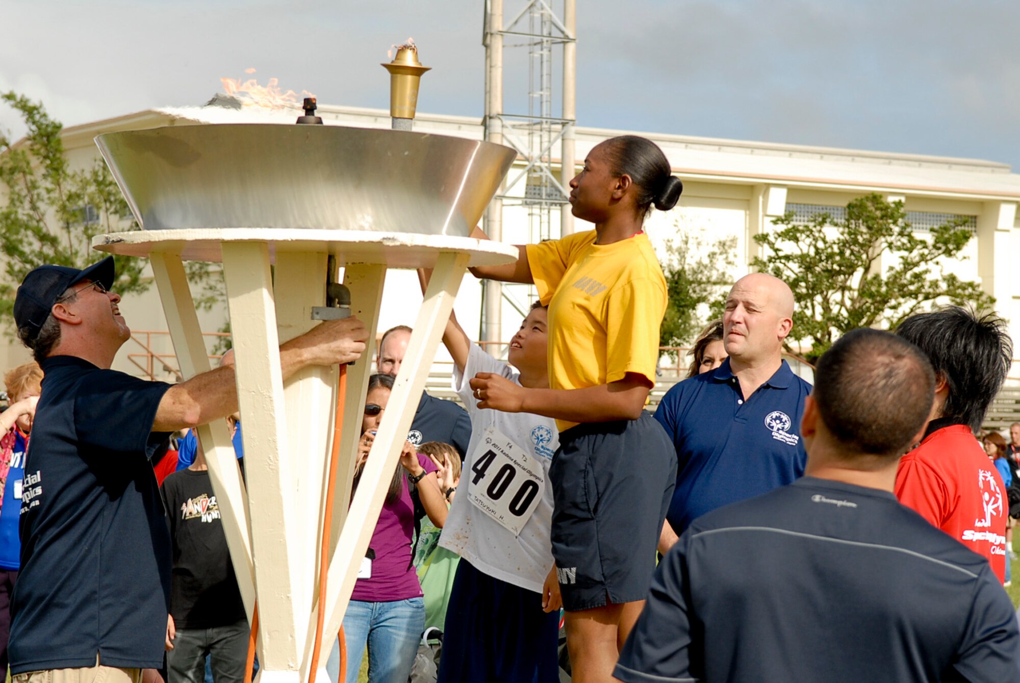 Selected athletes and huggers relight the ceremonial torch during the ending ceremony of the 12th Annual Kadena Special Olympics begins at Kadena Air Base, Japan, Nov. 5. About 5,000 people attended KSO festivities including nearly 2,000 American volunteers and 500 local national interpreters, along with senior officials from the Government of Japan, Okinawa Prefectural Government, local communities and the U.S. military. (U.S. Air Force photo/Airman 1st Class Tara A. Williamson/released)