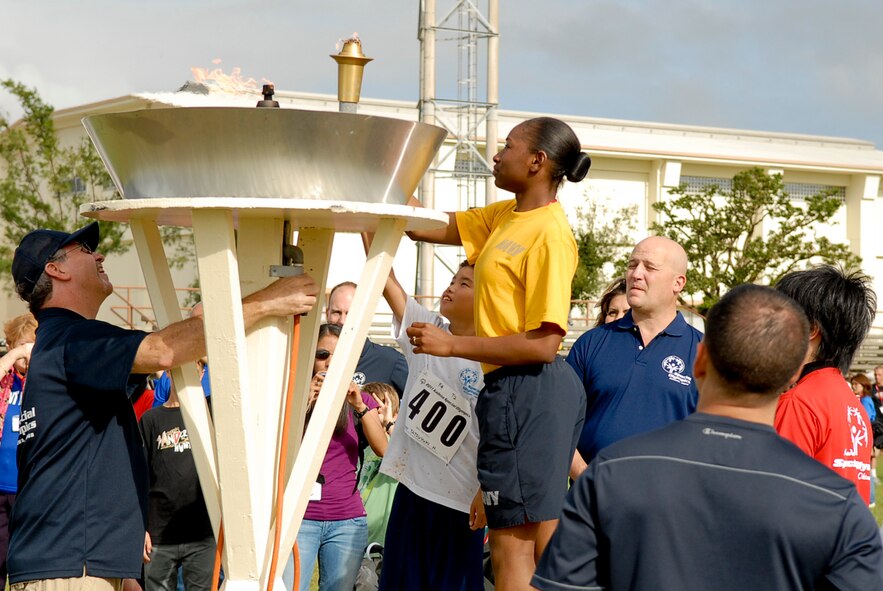 Selected athletes and huggers relight the ceremonial torch during the ending ceremony of the 12th Annual Kadena Special Olympics begins at Kadena Air Base, Japan, Nov. 5. About 5,000 people attended KSO festivities including nearly 2,000 American volunteers and 500 local national interpreters, along with senior officials from the Government of Japan, Okinawa Prefectural Government, local communities and the U.S. military. (U.S. Air Force photo/Airman 1st Class Tara A. Williamson/released)