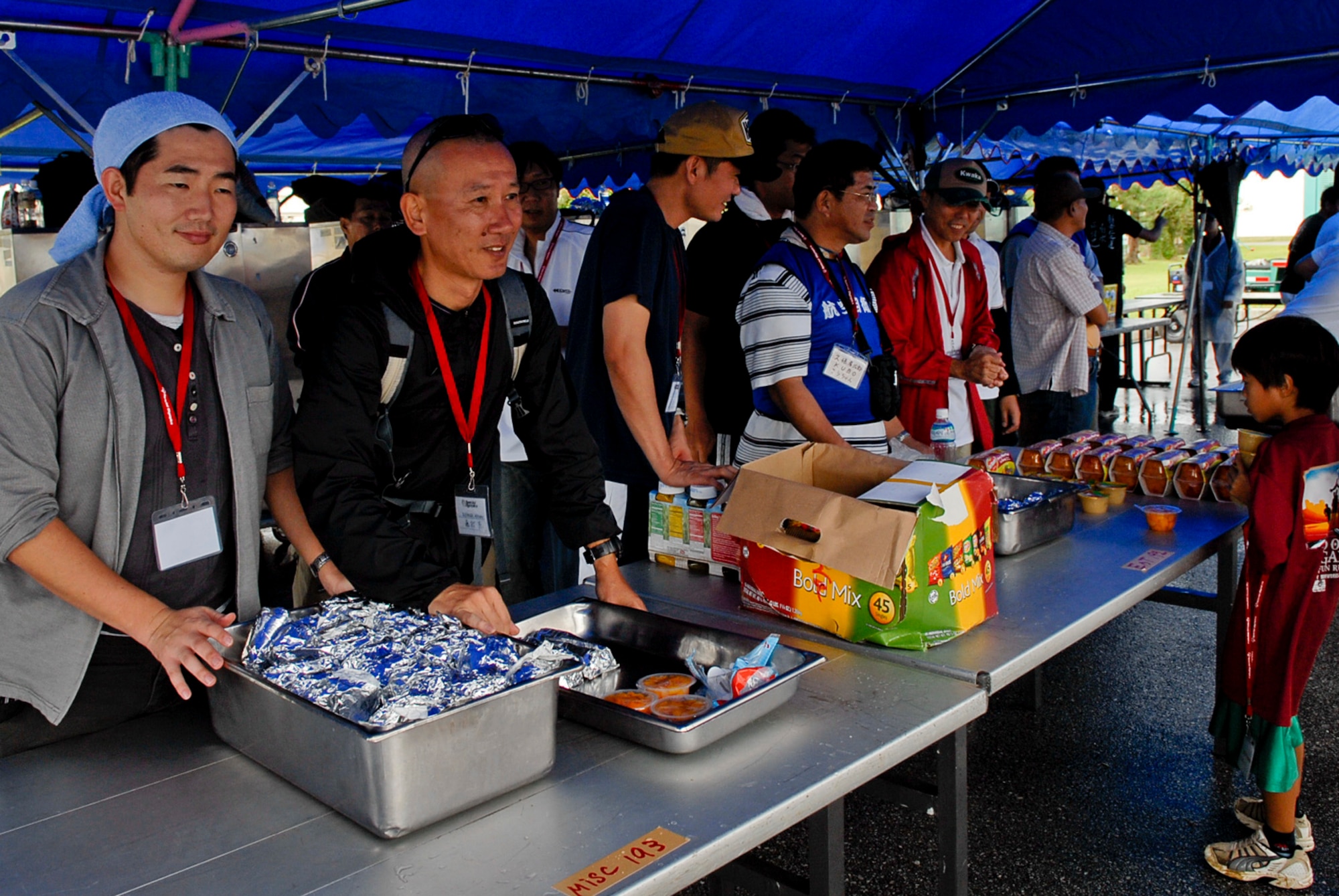Japanese Air Self Defense Force members volunteer their time to hand out food and drinks to participants in this year's Kadena Special Olympics at Kadena Air Base, Japan, Nov. 5. This year marks the 12th Annual KSO, a sporting event dedicated to enriching the lives of special-needs individuals while strengthening U.S. - Okinawa relationships. (U.S. Air Force photo/Airman 1st Class Tara A. Williamson/released)