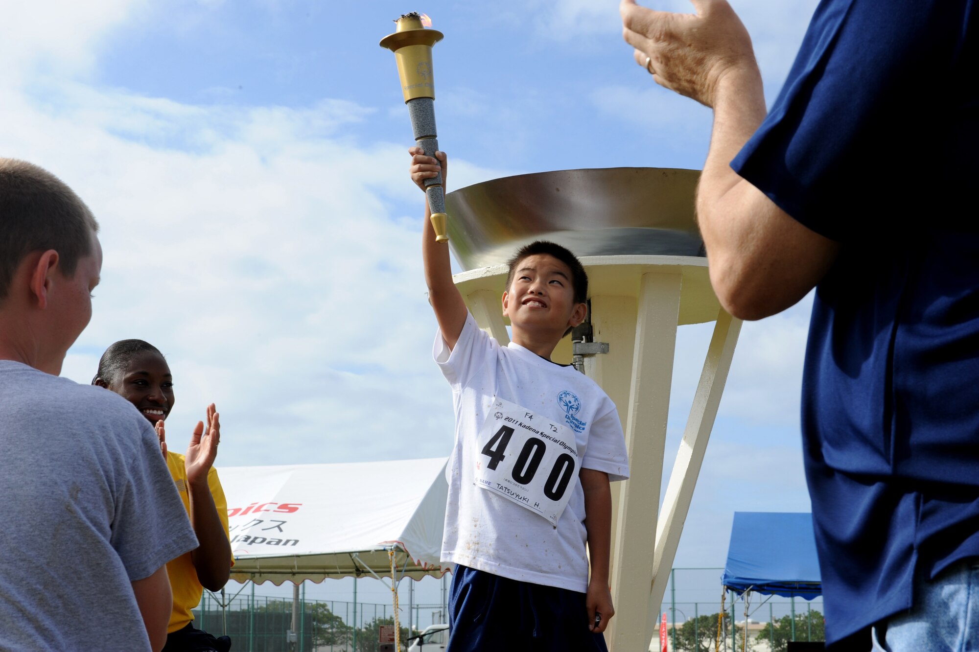 A Kadena Special Olympics athlete holds the torch during the event's ending ceremony on Kadena Air Base, Japan, Nov. 5. About 5,000 people attended KSO festivities including nearly 2,000 American volunteers and 500 local national interpreters, along with senior officials from the Government of Japan, Okinawa Prefectural Government, local communities and the U.S. military. (U.S. Air Force photo/A1C Justin Veazie/released)