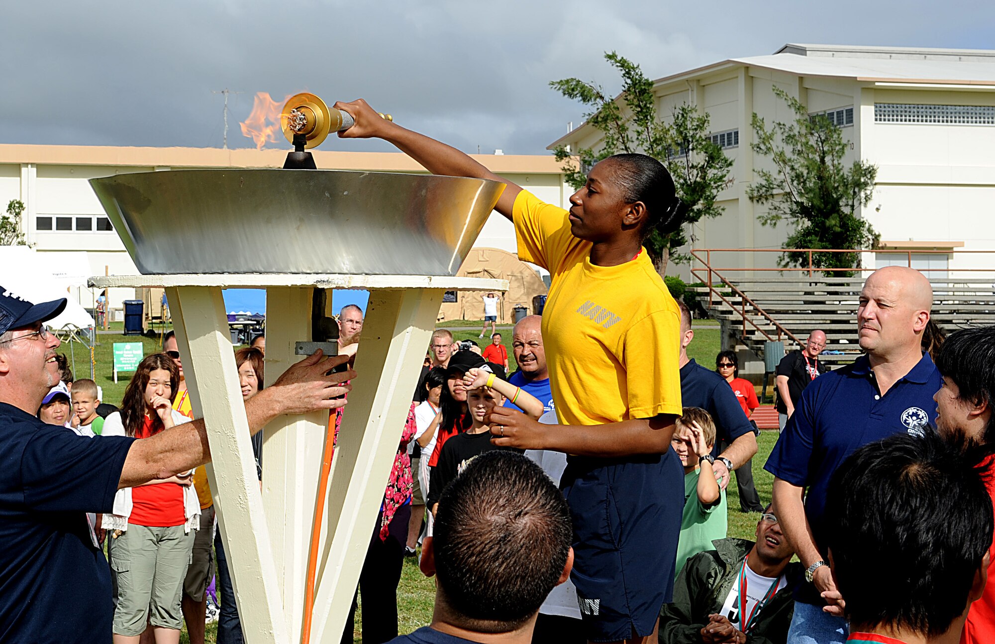 Selected athletes and huggers light the torch during the ending ceremony of the Kadena Special Olympics on Kadena Air Base, Japan, Nov. 5. The KSO is a one-day sporting and entertainment event with more than 870 special needs athletes and artists participating in competitions, music events and special recognition ceremonies. (U.S. Air Force photo/A1C Justin Veazie/released)