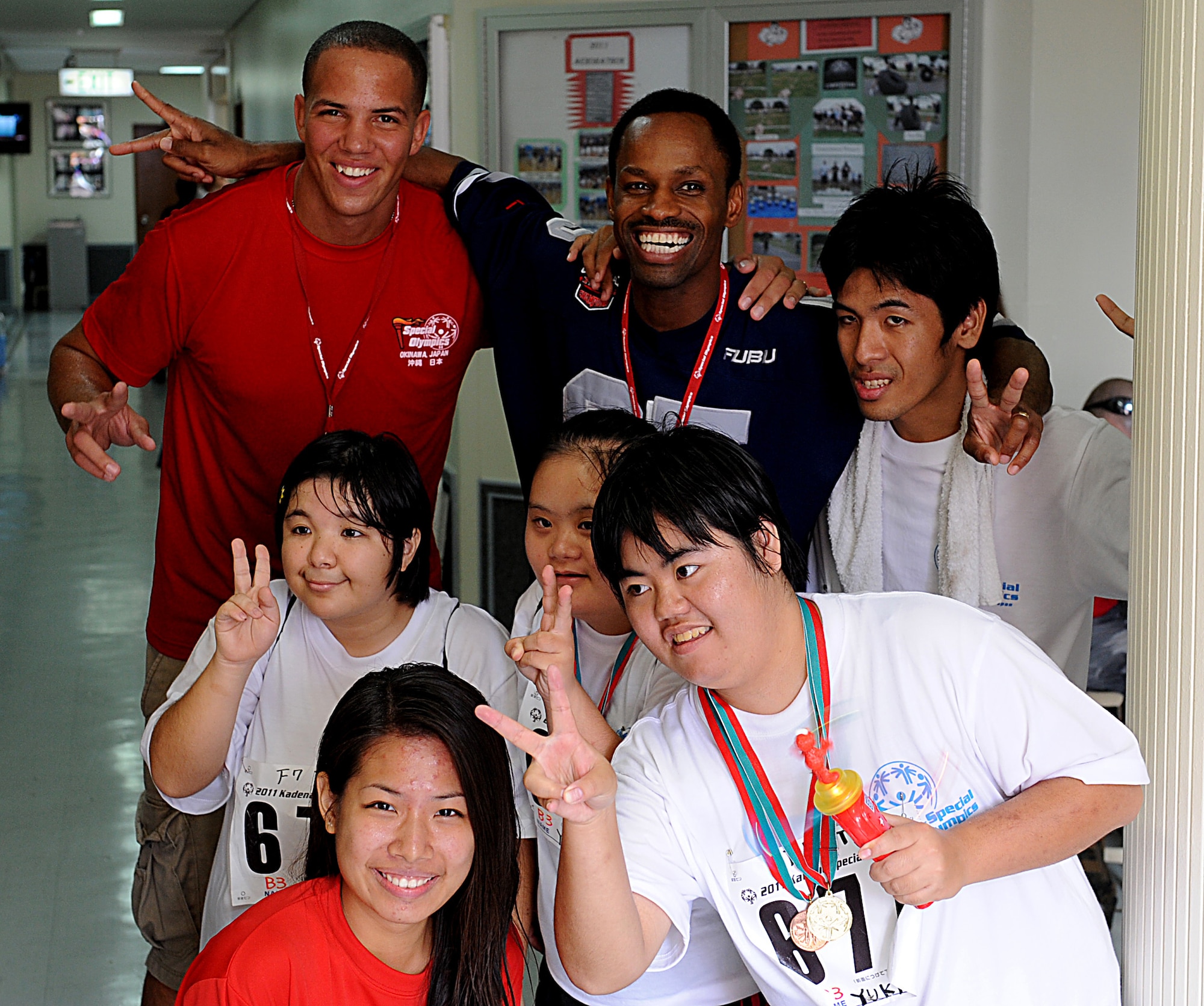 U.S. Air Force Chaplain Kennie Neal, 18th Wing, along with Kadena Special Olympics athletes and volunteers smile as their picture is taken on Kadena Air Base, Japan, Nov. 5. This year marks the 12th annual Kadena Special Olympics, a sporting event dedicated to enriching the lives of special-needs individuals. (U.S. Air Force photo/A1C Justin Veazie/released)