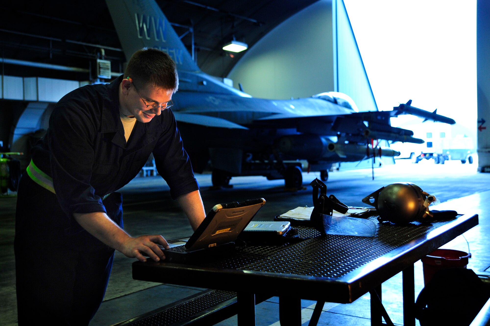 MISAWA AIR BASE, Japan - U.S. Air Force Senior Airman Christopher Kimmell, 14th Aircraft Maintenance Unit, checks his technical orders while working on a F-16 Fighting Falcon during an operational readiness exercise here Nov. 5. The 35th Fighter Wing is currently going through an ORE in preparation for an operational readiness inspection in December. (U.S. Air Force photo/Staff Sgt. Nathan Lipscomb)      
