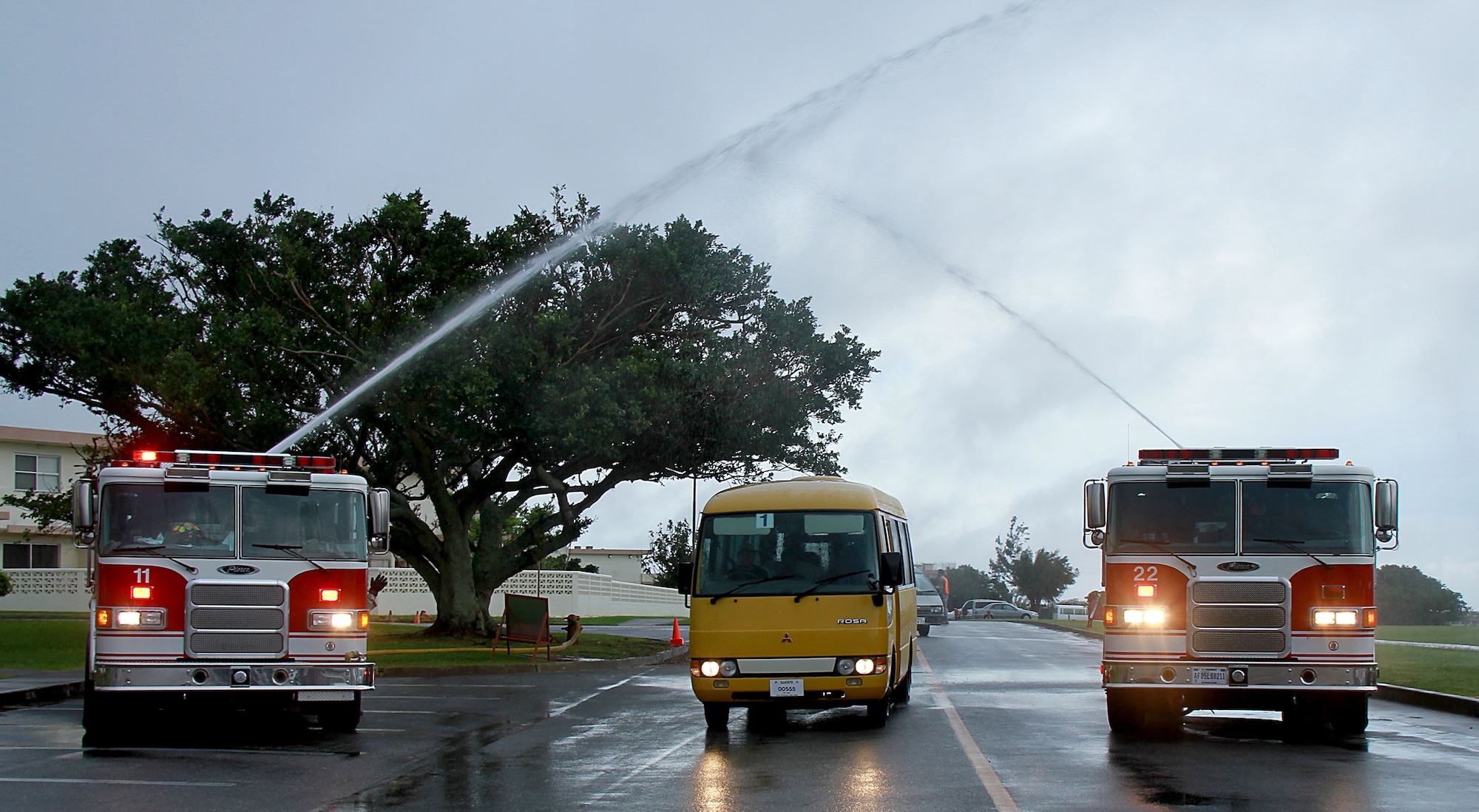 U.S. Air Force fire trucks welcome Kadena Special Olympics athletes with a water-arch, Kadena Air Base, Japan, Nov. 5. This year marks the 12th annual KSO, a sporting event dedicated to enriching the lives of special-needs individuals while strengthening U.S.-Okinawa relationships.(U.S. Army photo/Chip Steitz/released)