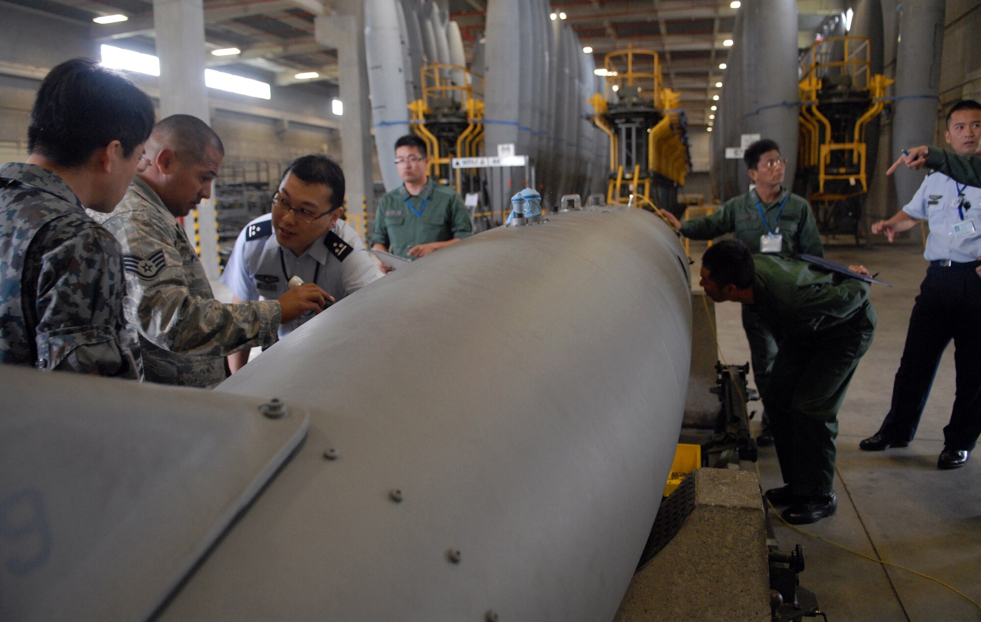 Members of the Japan Air Self Defense Force maintenance division out of Naha inspect an F-15C external fuel tank?s internal components. Airmen from the 18th Component Maintenance Squadron illustrated how inspections are done within the 18 Maintenance Group on Oct. 31 at Kadena Air Base, Japan. ?We really appreciate this kind of tour from the 18th Wing,? said Maj. Yaji, the maintenance branch chief from the Japan Air Defense Command, located in Tokyo Japan. ?We learned many things about how to better store our equipment and inspect it more regularly. We also got to know each other at a working level, and we enjoy having these opportunities.? (U.S. Air Force photo/Senior Airman Sara Csurilla)  