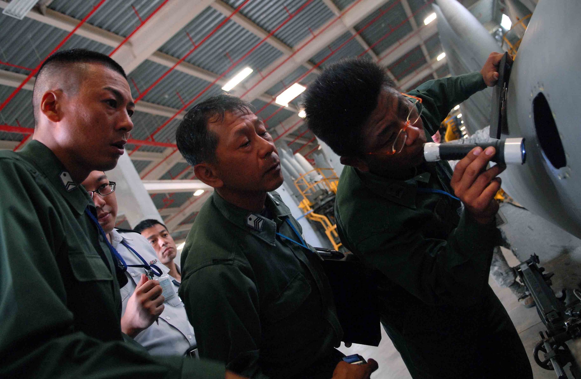 Members of the Japan Air Self Defense Force maintenance division out of Naha inspect an F-15C external fuel tank?s internal components. Airmen from the 18th Component Maintenance Squadron illustrated how inspections are done within the 18 Maintenance Group on Oct. 31 at Kadena Air Base, Japan. ?We really appreciate this kind of tour from the 18th Wing,? said Maj. Yaji, the maintenance branch chief from the Japan Air Defense Command, located in Tokyo Japan. ?We learned many things about how to better store our equipment and inspect it more regularly. We also got to know each other at a working level, and we enjoy having these opportunities.? (U.S. Air Force photo/Senior Airman Sara Csurilla)  