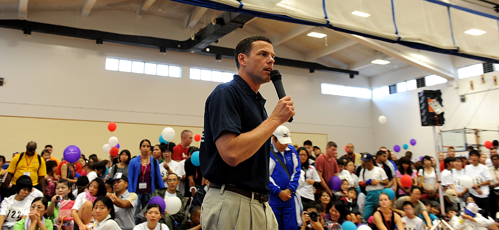 U.S. Air Force Brig. Gen. Matt Molloy, 18th Wing commander, gives opening remarks at the start of the Kadena Special Olympics on Kadena Air Base, Japan, Nov. 5, 2011. More than 440 special-needs artists from around Okinawa hosted an art exhibit throughout the day during the 12th Annual KSO. (U.S. Air Force photo/Airman 1st Class Brooke P. Beers/released)