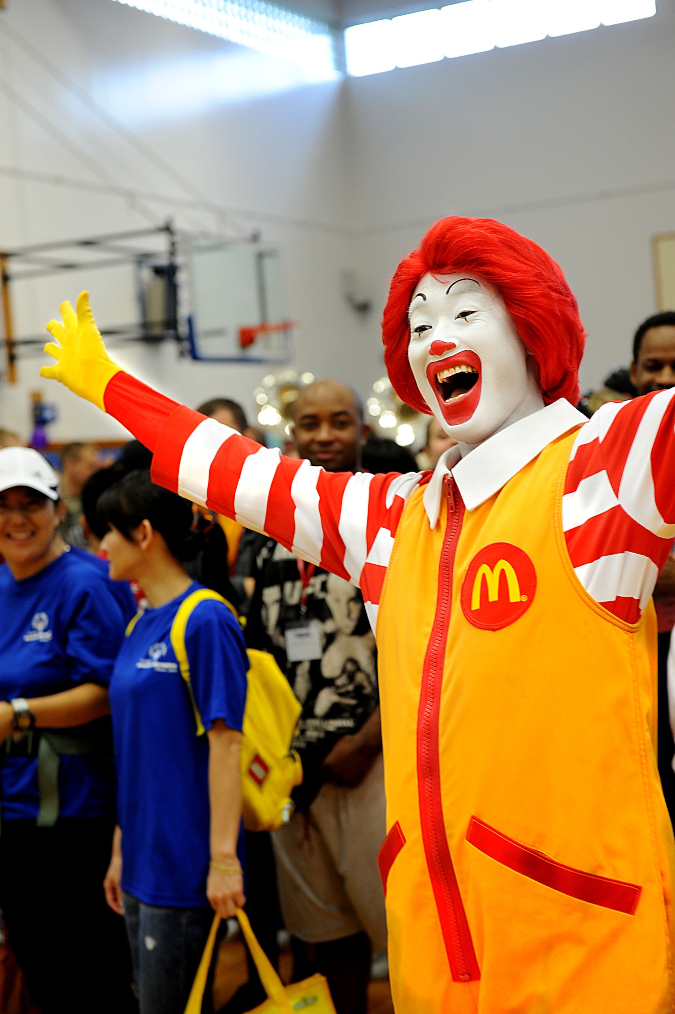 Ronald McDonald brightens up a rainy day with a smile during Kadena Special Olympics, Kadena Air Base, Japan, Nov. 5, 2011. KSO began in 2000 with approximately 400 athletes and 600 volunteers as an 18th Wing community goodwill initiative to strengthen U.S. - Okinawa relationships. Eleven years later, the event has doubled in size and participation. (U.S. Air Force photo/Airman 1st Class Brooke P. Beers/released)