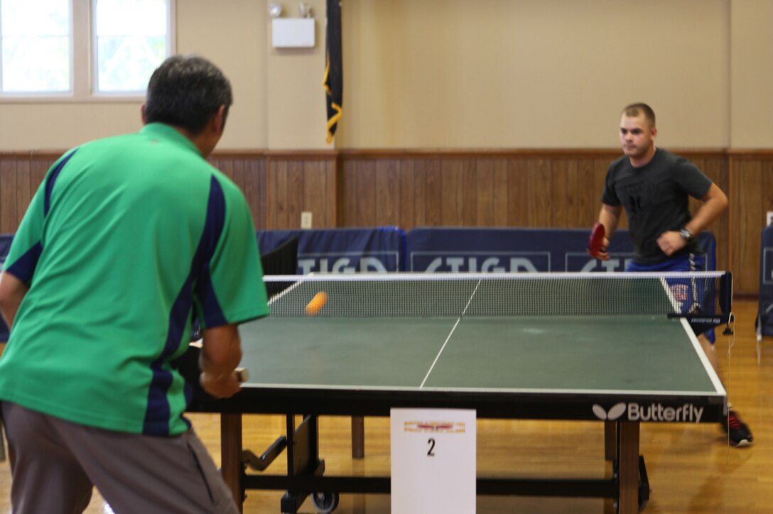 Daniel Leung defends his winning streak against an opponent at the Camp Lejeune Ping Pong Clubs 4th Annual Tournament. Daniel Leung was undefeated and won first place in the advanced tournament. (Official U.S. Marine Corps photo by Pfc. Jackeline M. Perez Rivera)