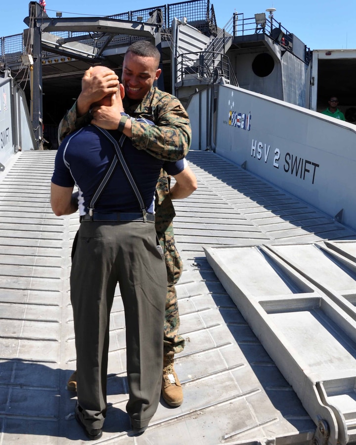 U.S. Marine Corps SSgt. Garival Perez, HSV 2 Marine Corps Detachment (MARDET), greets his father, Eleodoro Perez on the ramp of the Swift. The Swift is deploying on Southern Partnership Station (SPS) 2012. SPS is an annual deployment of U.S. ships to the U.S. Southern Command’s area of responsibility in the Caribbean, Central and South America. This mission involves sharing information between local host countries Navies, Coast Guards and civilian services throughout the region.