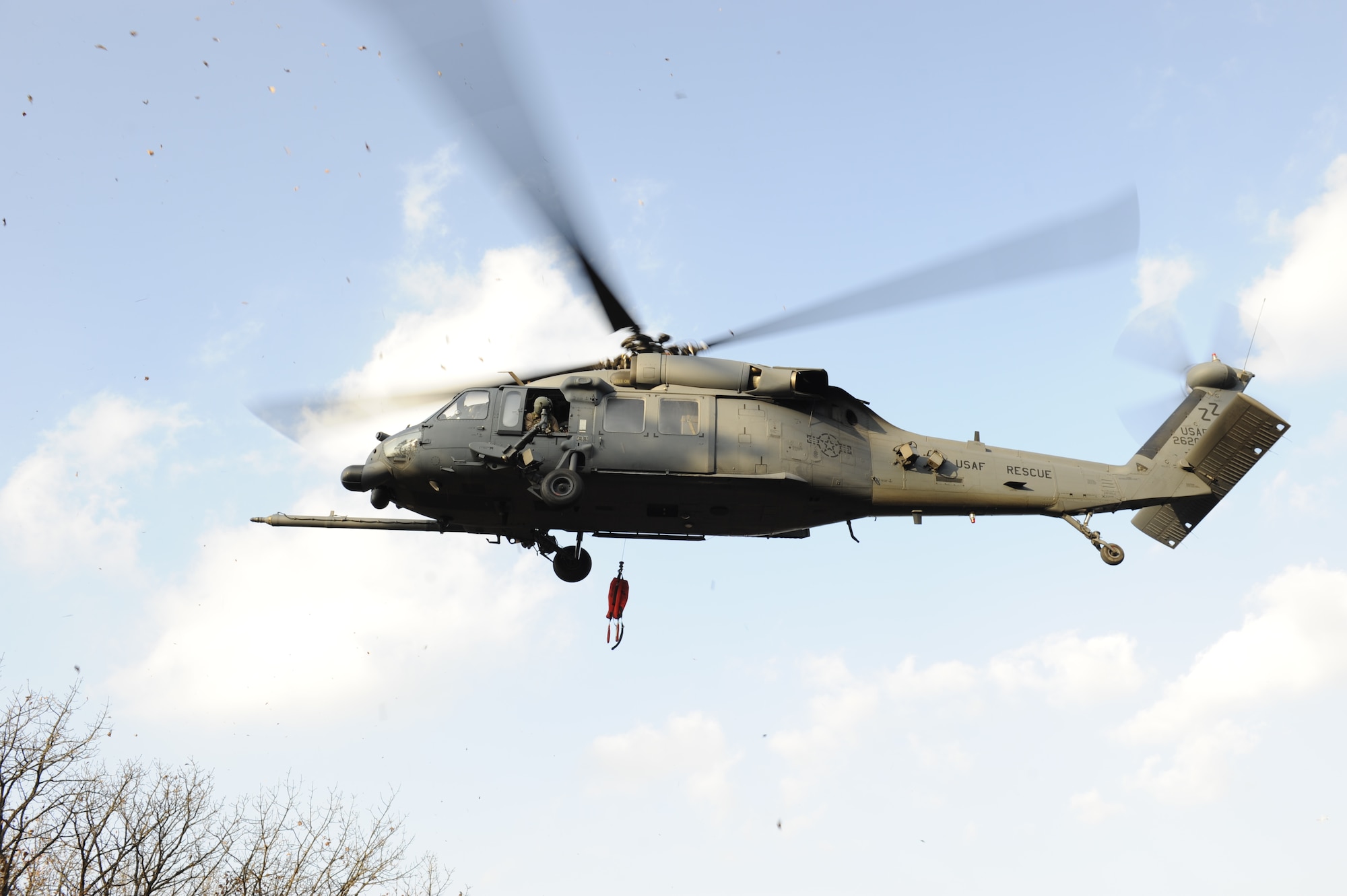 A U.S. Air Force HH-60G Pave Hawk from the 33rd Rescue Squadron on Kadena Air Base, Japan, raises its hoist after lowering personnel down into the mountains near Osan Air Base, Republic of Korea, during PACIFIC THUNDER, Nov. 3.
PACIFIC THUNDER is a 10-day exercise from Oct. 31 to Nov. 9 at Osan AB. The exercise involves the 33rd Rescue Squadron from Kadena AB, Japan, and the 25th Fighter Squadron from Osan. These units work together to practice combat search and rescue tactics to prepare for real-world emergency situations. (U.S. Air Force photo/Tech. Sgt. Angelique Bilog/released)

