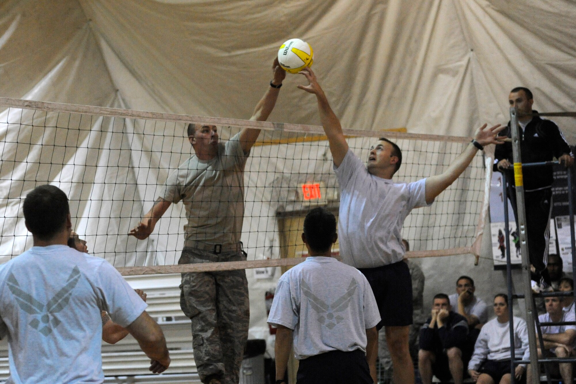 Staff Sgt. James De Geus (right) attempts to block a return during a volleyball tournament at the Transit Center at Manas, Kyrgyzstan, Nov. 5. The Wing Staff Agency team defeated the 376th Expeditionary Security Forces team in a double elimination game moving them to the final round of competition. The WSA team earned second place in the tournament. De Geus is deployed to the 376th Air Expeditionary Wing command post as a controller from Buckley Air Force Base, Colo. (U.S. Air Force photo/Tech. Sgt. Tammie Moore)