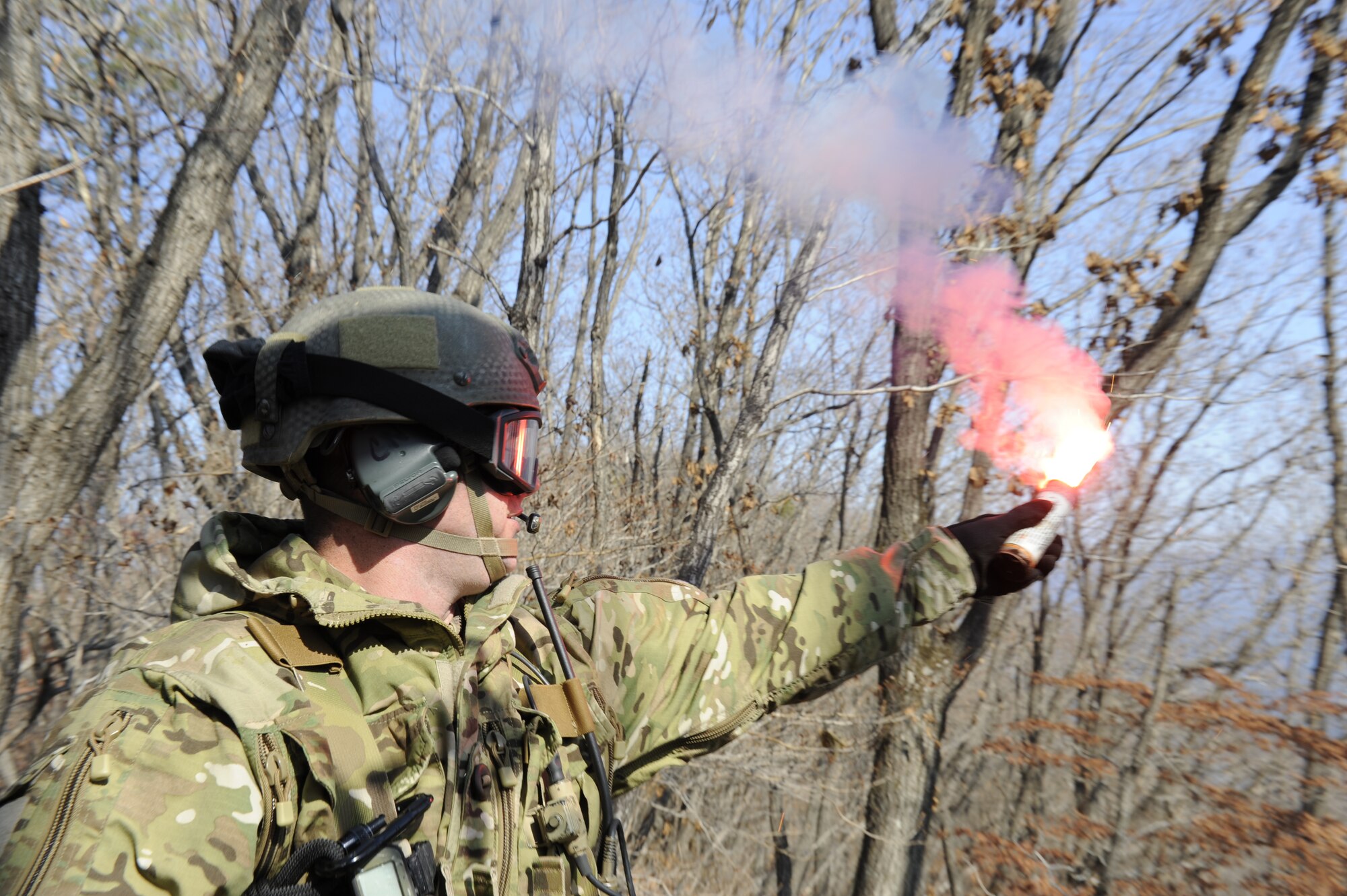 U.S. Air Force Staff Sgt. Robert Colliton, Survival Evasion Resistance Escape specialist from the 18th Operation Support Squadron on Kadena Air Base, Japan, pops smoke as a signal to rescue aircraft so they can pinpoint his location during exercise PACIFIC THUNDER Nov. 3 near Osan Air Base, Republic of Korea.
PACIFIC THUNDER is a 10-day exercise from Oct. 31 to Nov. 9 at Osan AB. The exercise involves the 33rd Rescue Squadron from Kadena AB, Japan, and the 25th Fighter Squadron from Osan. These units work together to practice combat search and rescue tactics to prepare for real-world emergency situations. (U.S. Air Force photo/Tech. Sgt. Angelique Bilog/released)
