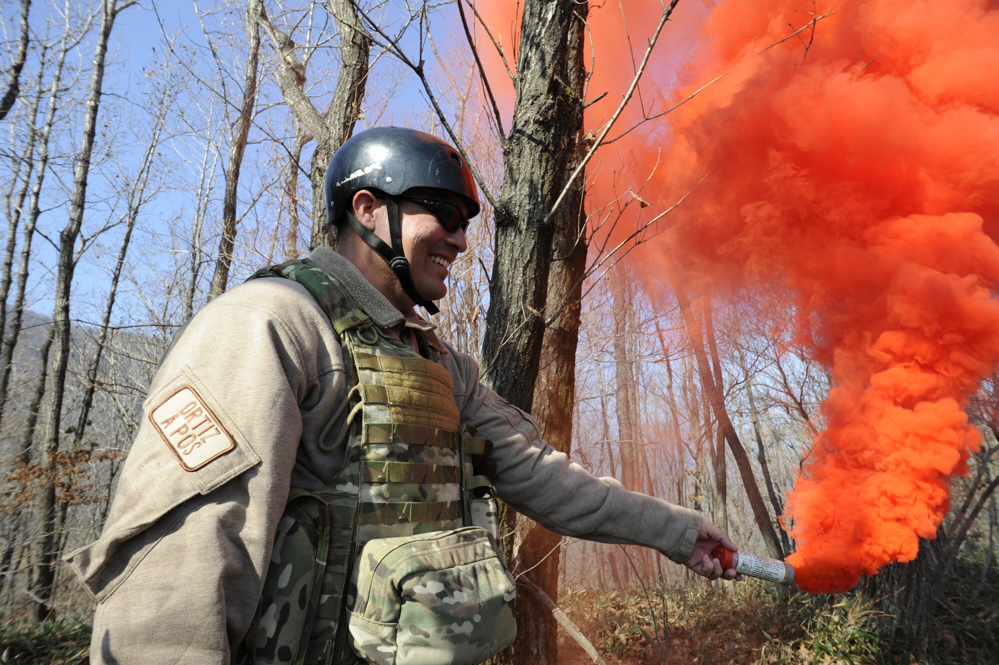 U.S. Air Force Lt. Col. Pete Ortiz Jr., 33rd Rescue Squadron director of operations on Kadena Air Base, Japan, pops smoke as a signal to rescue aircraft so they can pinpoint his location during exercise PACIFIC THUNDER Nov. 3 near Osan Air Base, Republic of Korea.
PACIFIC THUNDER is a 10-day exercise from Oct. 31 to Nov. 9 at Osan AB. The exercise involves the 33rd Rescue Squadron from Kadena AB, Japan, and the 25th Fighter Squadron from Osan. These units work together to practice combat search and rescue tactics to prepare for real-world emergency situations. (U.S. Air Force photo/Tech. Sgt. Angelique Bilog/released)
