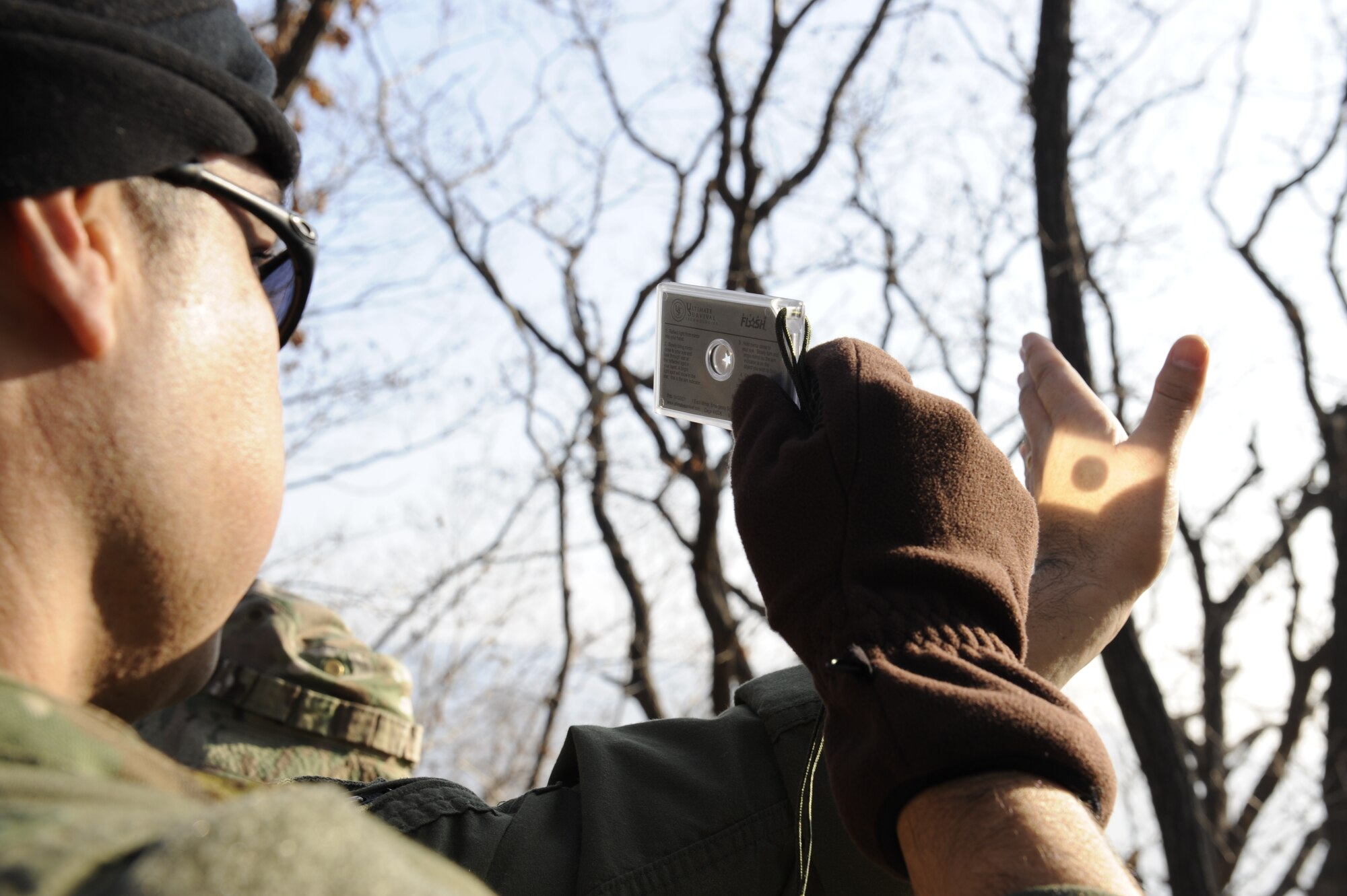 U.S. Air Force Lt. Col. Pete Ortiz Jr., 33rd Rescue Squadron director of operations on Kadena Air Base, Japan, uses a mirror to flash a signal to rescue aircraft so they can pinpoint his location during exercise PACIFIC THUNDER Nov. 3 near Osan Air Base, Republic of Korea.
PACIFIC THUNDER is a 10-day exercise from Oct. 31 to Nov. 9 at Osan AB. The exercise involves the 33rd Rescue Squadron from Kadena AB, Japan, and the 25th Fighter Squadron from Osan. These units work together to practice combat search and rescue tactics to prepare for real-world emergency situations. (U.S. Air Force photo/Tech. Sgt. Angelique Bilog/released)
