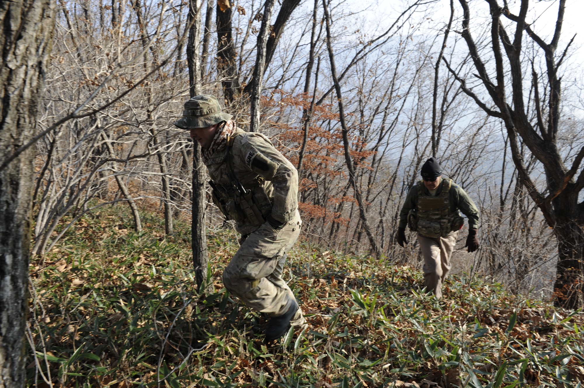 U.S. Air Force Staff Sgt. Robert Colliton, Survival Evasion Resistance Escape specialist from the 18th Operation Support Squadron, and Lt. Col. Pete Ortiz Jr., 33rd Rescue Squadron director of operations on Kadena Air Base, Japan, head out to the helicopter pick-up point during exercise PACIFIC THUNDER Nov. 3 near Osan Air Base, Republic of Korea.
PACIFIC THUNDER is a 10-day exercise from Oct. 31 to Nov. 9 at Osan AB. The exercise involves the 33rd Rescue Squadron from Kadena AB, Japan, and the 25th Fighter Squadron from Osan. These units work together to practice combat search and rescue tactics to prepare for real-world emergency situations. (U.S. Air Force photo/Tech. Sgt. Angelique Bilog/released)
