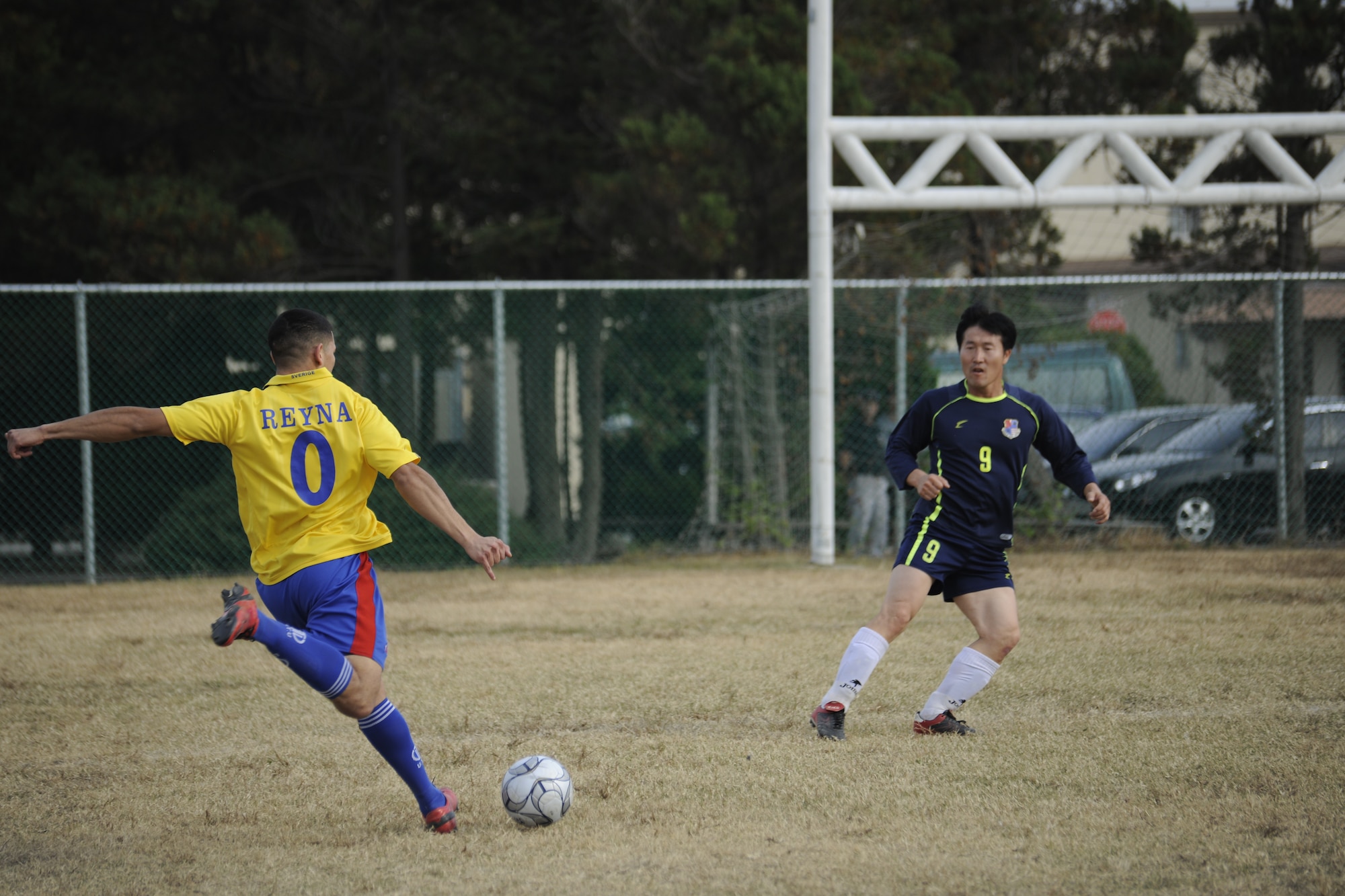 Airman 1st Class Ricardo Reyna, 8th Security Forces Squadron response force leader, attempts to kick the soccer ball for a goal against a Korean Union team member at a soccer event during the Korean-American Sports Day at Kunsan Air Base, Republic of Korea, Nov. 2, 2011. The day had various events including soccer, tug-of-war and paintball. (U.S. Air Force photo by Staff Sgt. Rasheen Douglas/Released)