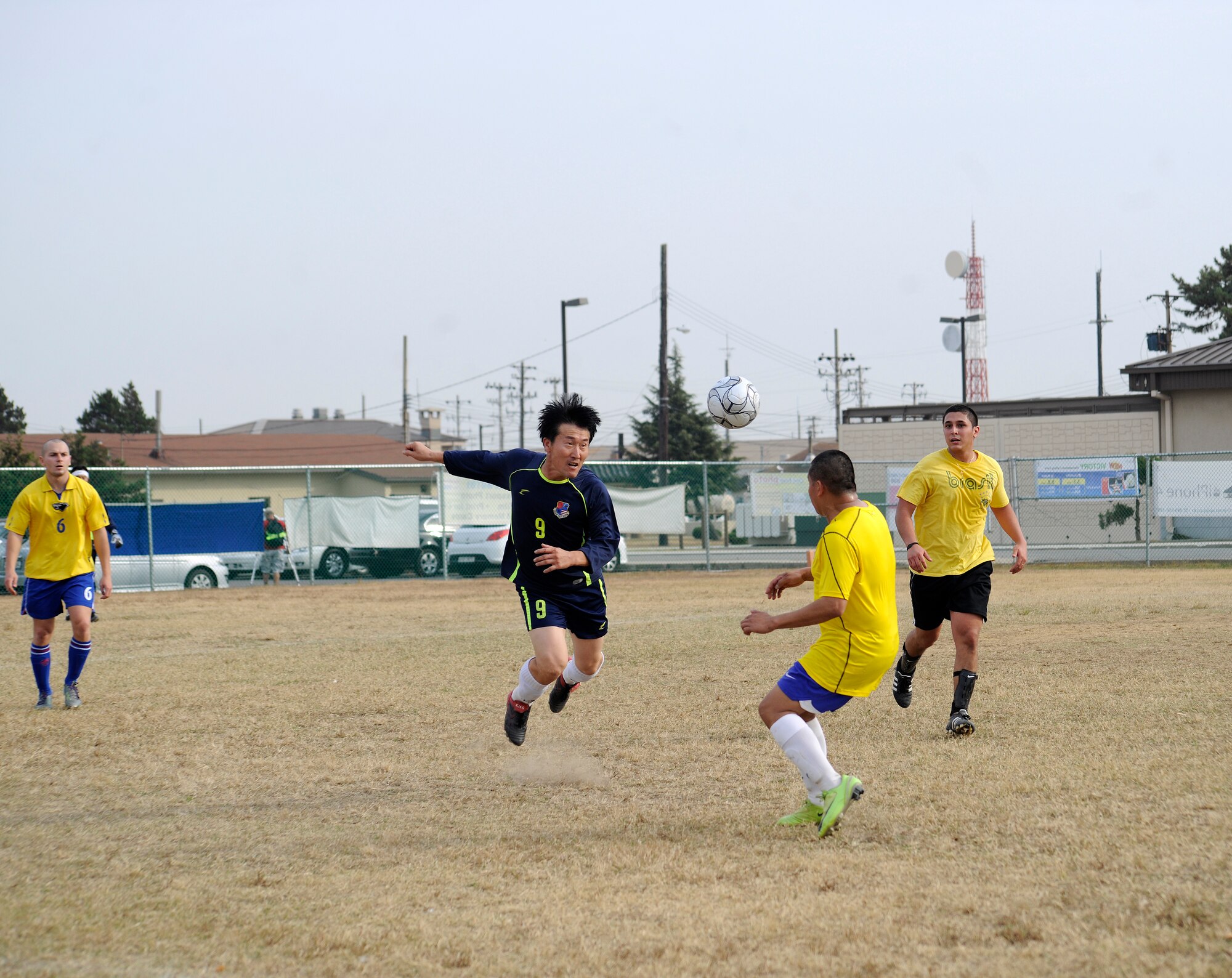 A Korean Union team member hits the soccer ball with his head in an attempt to keep Airmen from the 8th Fighter Wing from getting the ball at a soccer event during the Korean-American Sports Day at Kunsan Air Base, Republic of Korea, Nov. 2, 2011. The day had various events including soccer, tug-of-war and paintball. (U.S. Air Force photo by Staff Sgt. Rasheen Douglas/Released)