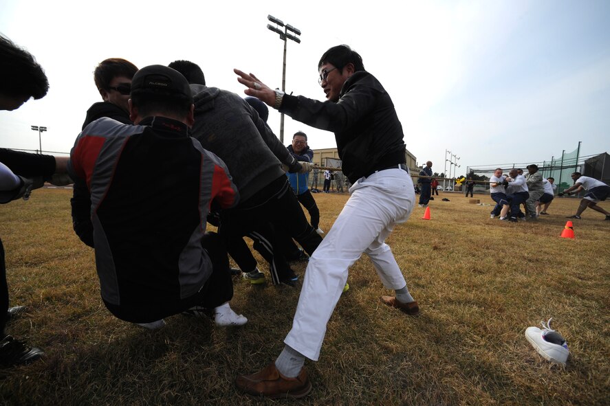 Korean Union team members pull the rope against the 8th Security Forces Squadron team during a tug-of-war event as part of the Korean-American Sports Day at Kunsan Air Base, Republic of Korea, Nov. 2, 2011. The day had various events including softball, tug-of-war and paintball. (U.S. Air Force photo by Staff Sgt. Rasheen Douglas/Released)