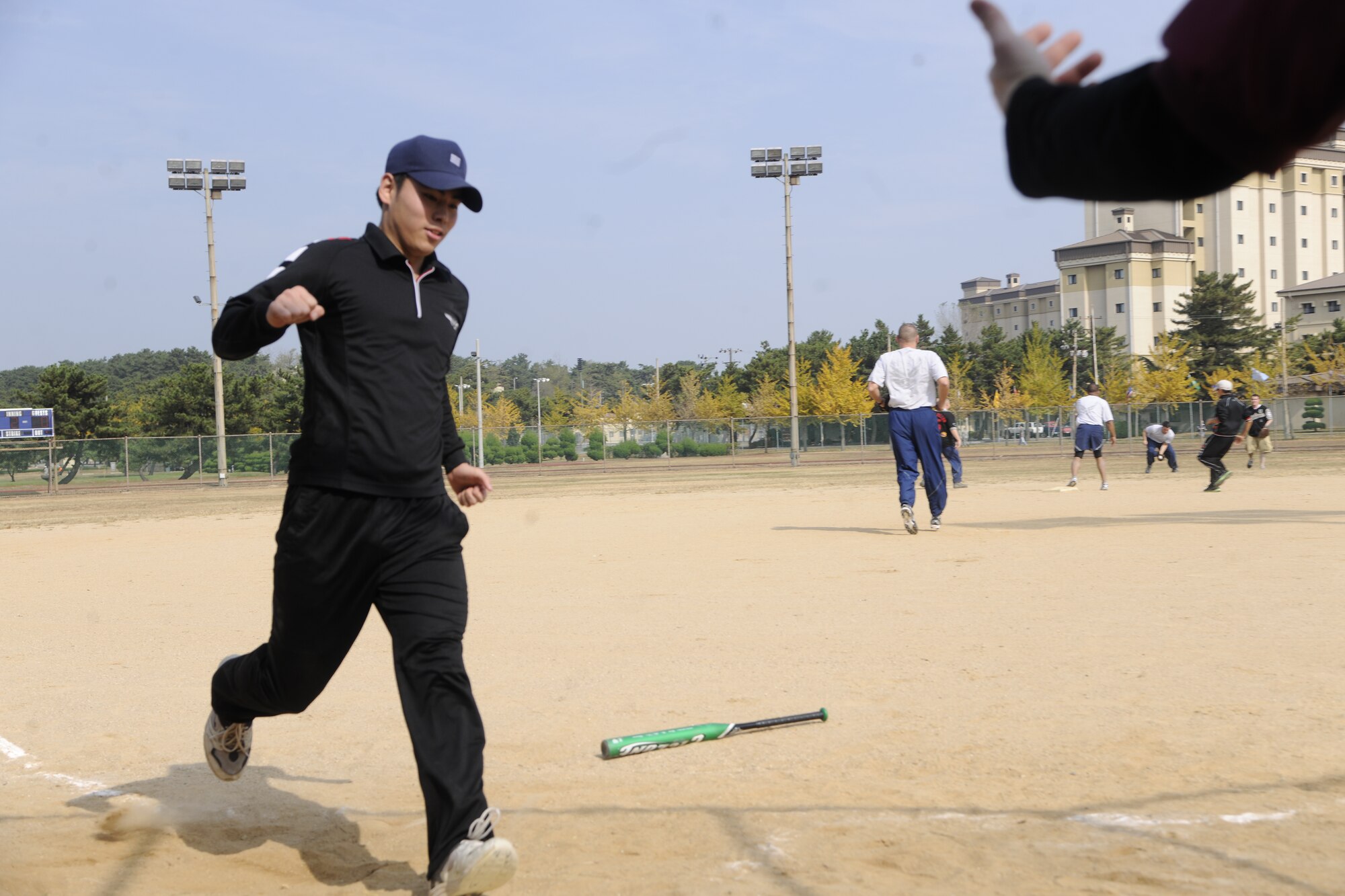 A member of the Republic of Korea Air Force crosses home plate after a base hit while playing the 8th Force Support Squadron team during the Korean-American Sports Day at Kunsan Air Base, Republic of Korea, Nov. 2, 2011. The day had various events including softball, tug-of-war and paintball. (U.S. Air Force photo by Staff Sgt. Rasheen Douglas/Released)