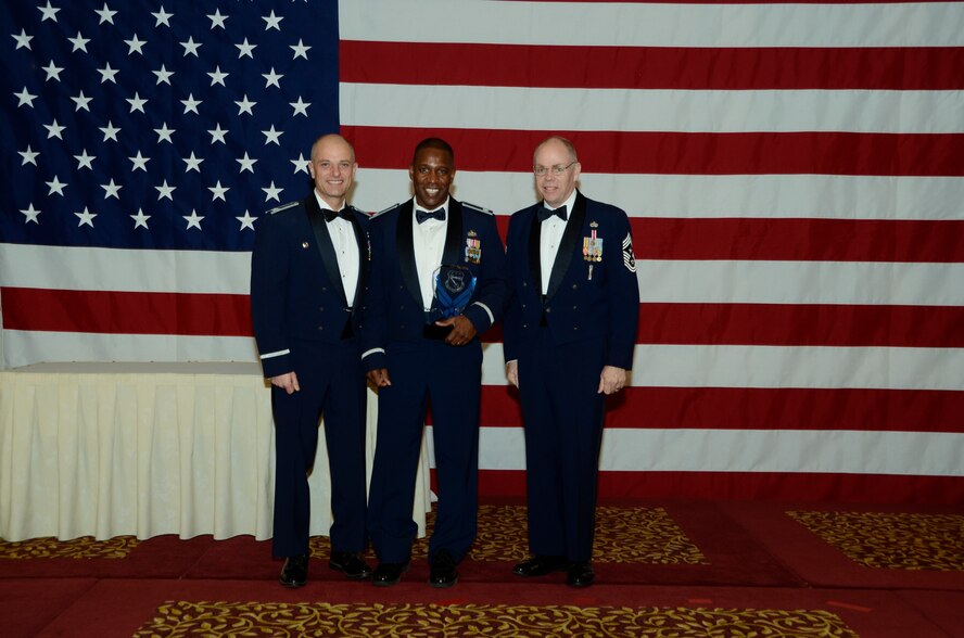 Air Force Lt. Col. Jeremy Simmons, 144th Civil Engineer Squadron, is awarded the company grade officer Outstanding Airman of the Year award on Nov. 6, 2011 by Col. Sami D. Said, 144th Fighter Wing Commander and Chief Master Sgt. Joseph E. Thornell, 144th Fighter Wing Command Chief, Fresno, Calif. The Outstanding Airman of the Year banquet is held annually to highlight exceptional individual performance.  (U.S. Air Force photo by Tech Sgt Robin Meredith)