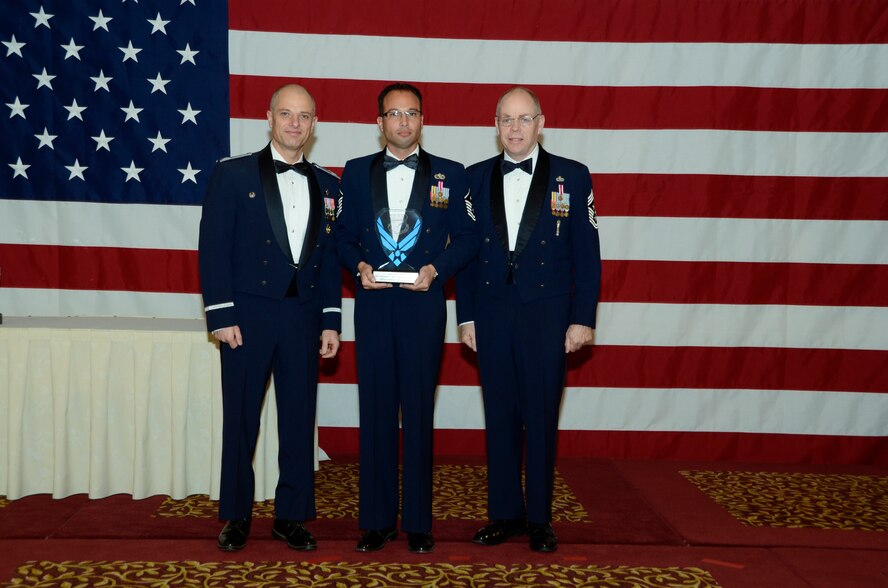 Air Force Master Sgt. Anthony M. Achimasi, 144th Mission Support Group, is awarded the first sergeant Outstanding Airman of the Year award on Nov. 6, 2011 by Col. Sami D. Said, 144th Fighter Wing Commander and Chief Master Sgt. Joseph E. Thornell, 144th Fighter Wing Command Chief, Fresno, Calif. The Outstanding Airman of the Year banquet is held annually to highlight exceptional individual performance.  (U.S. Air Force photo by Tech Sgt Robin Meredith)