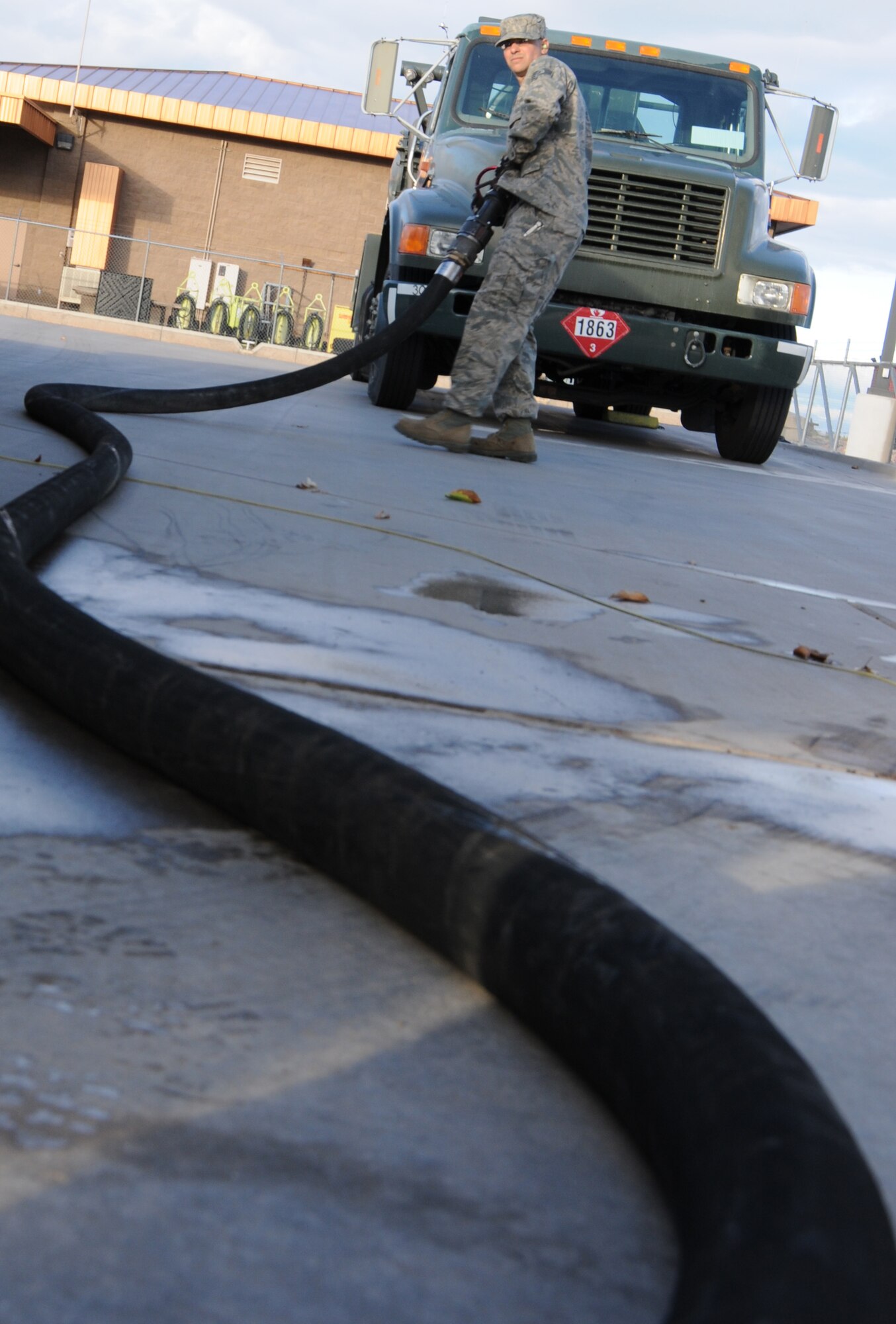 Staff Sgt. Matthew Salamone, 161st Logistics Readiness Group fuels technician, pulls a fuel hose on a fuel truck as part of a routine inspection during an aircraft generation exercise, Phoenix, Nov. 5, 2011. In order to maintain safety on the flightline, these six thousand gallon fuel trucks are inspected daily for leaks and cracks in the pipes. (U.S. Air Force Photo by Staff Sgt. Courtney Enos/Released)