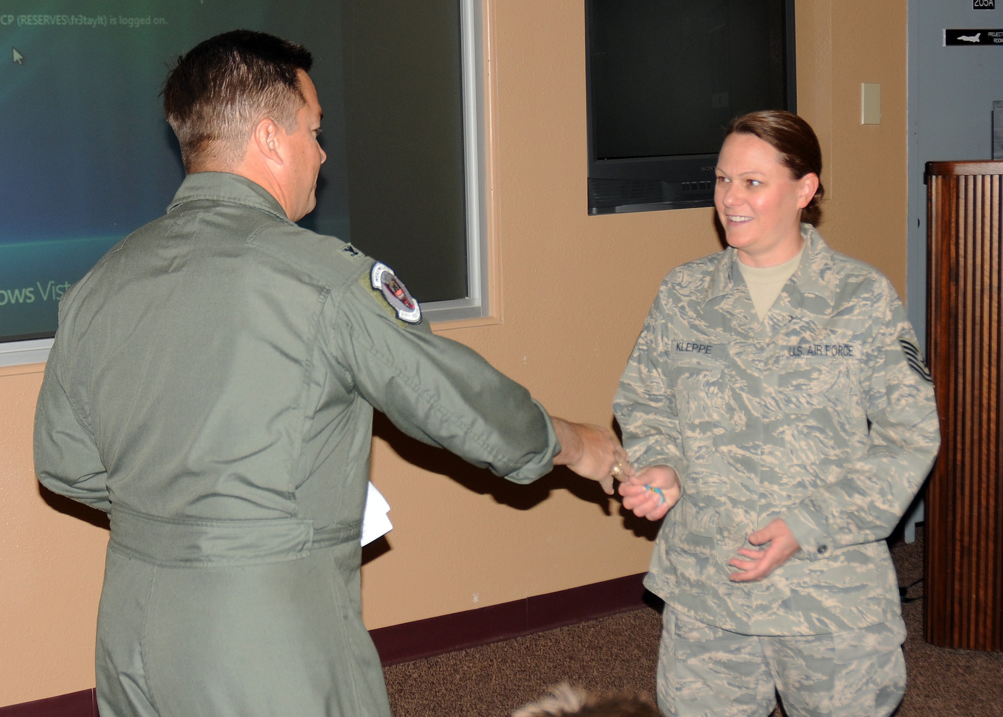 Col. Christopher F. Yancy, 944th Fighter Wing vice wing commander,
recognized Tech. Sgt Tracey Kleppe, 944th Fighter Wing command post senior controller, by presenting a wing coin Nov.6 during a SORTS meeting here. Kleppe received the coin for being recognized as an outstanding professional performer during the 56th Fighter Wing Unit Compliance Inspection. (U.S. Air Force photo\Staff Sgt. Louis Vega Jr.)
