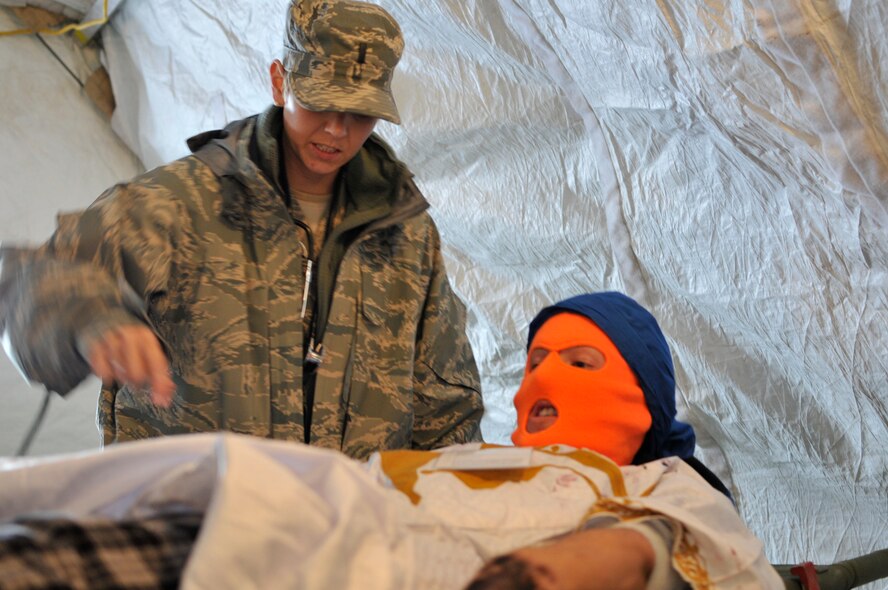 U.S. Air Force Lt. Andie Cook, Physicians Assistant, 151st Medical Group, stabilizes an injured patient during a training exercise at the Utah Air National Guard Base in Salt Lake City Utah, Oct 5, 2011. Lt. Cook is participating in the Expeditionary Medical Support exercise, a certification review field exercise which prepares medical personnel for deployment. (U.S. Air Force photo by Technical Sgt. Jeremy Giacoletto-Stegall)(RELEASED)