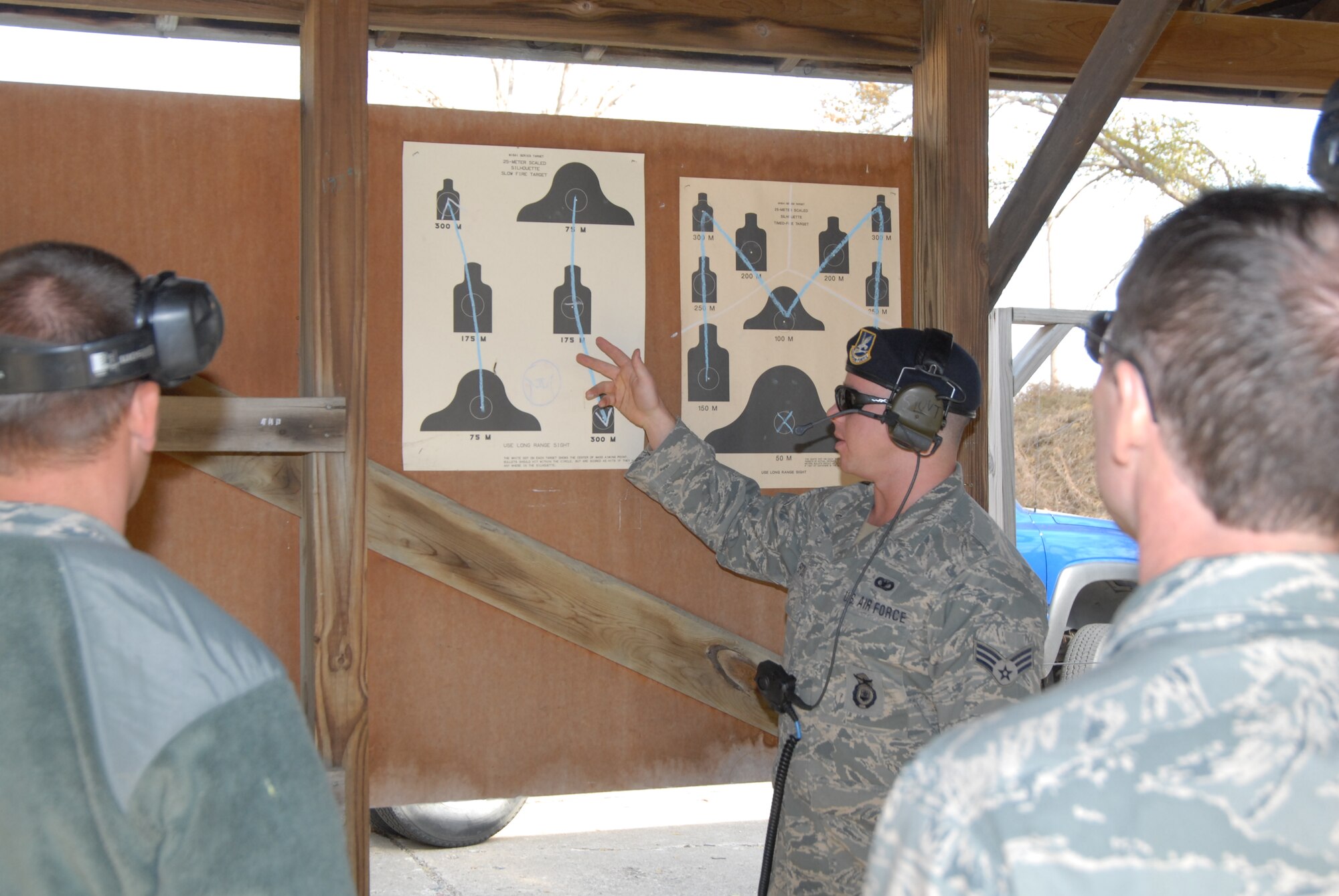 Senior Airman Russel Stout explains the course of fire to members of the 185th Air Refuleing Wing, Sioux City, Iowa, on 5 November, 2011. The 185th's CATM is responsible for both training airmen in combat arms and maintaining the weapons. (US Photo by 2LT Jeremy J. McClure)