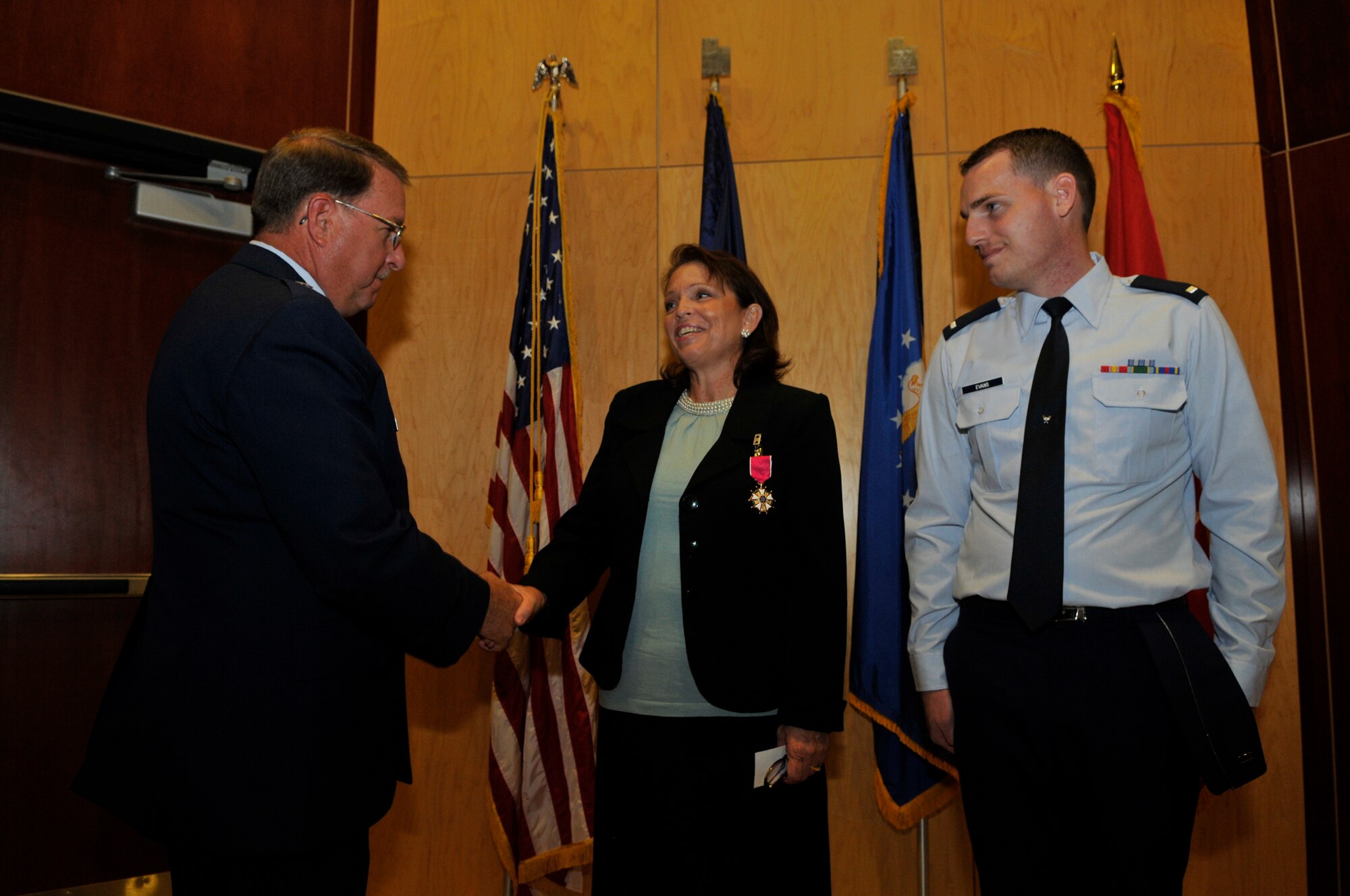 Brig. Gen. Wayne E. Lee presents the Legion of Merit award in honor of the late Col. Bruce C. Evans to his wife, Mrs. Connie Evans, and his son, 1st Lt. Benjamin Evans.  Colonel Evans was awarded the Legion of Merit posthumously for exceptionally meritorious conduct as the state staff Judge Advocate with the Utah Air National Guard Headquarters. (Air Force photo by TSgt Jeremy Giacoletto-Stegall)