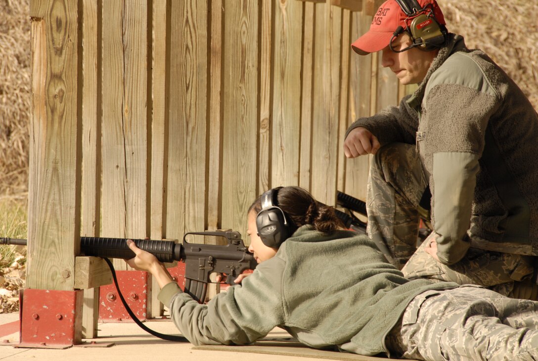 Staff Sergeant Thad Miller, a Security Forces (CATMS) member of the 185th Air Refueling Wing, Sioux City, Iowa, supervises a fellow Air National Guardsman as she fires for qualification on 6 November, 2011. (US Air Force photo by TSgt Brian Cox) 