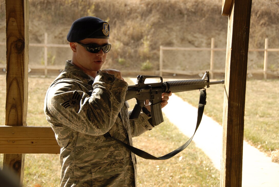 Senior Airman Russell Stout, a Security Forces member of the 185th Air Refueling Wing, Sioux City, Iowa, instructs fellow Air National Guardsmen in weapons safety and operation before firing for qualification on 6 November, 2011. (US Air Force photo by TSgt Brian Cox) 