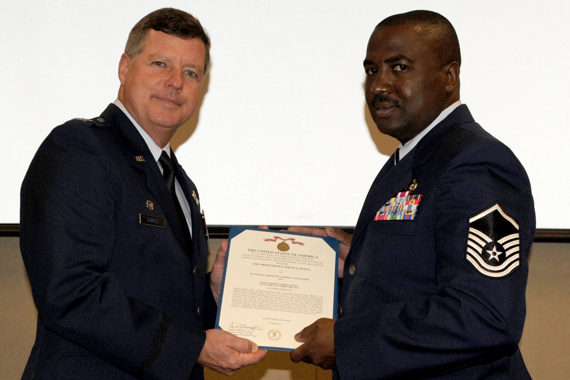 U.S. Air Force Col. Keith Schultz, 307th Operations Group commander, presents the Meritorious Service Medal to Master Sgt. Albertus Alexander, a B-52 Aircrew Flight Equipment specialist, during a ceremony at Barksdale Air Force Base, La., Nov. 5, 2011. Alexander received the medal for outstanding achievement while supporting the 307th Operations Support Flight from July 1, 2009 to Feb. 1, 2010. (U.S. Air Force photo by Master Sgt. Greg Steele/Released)