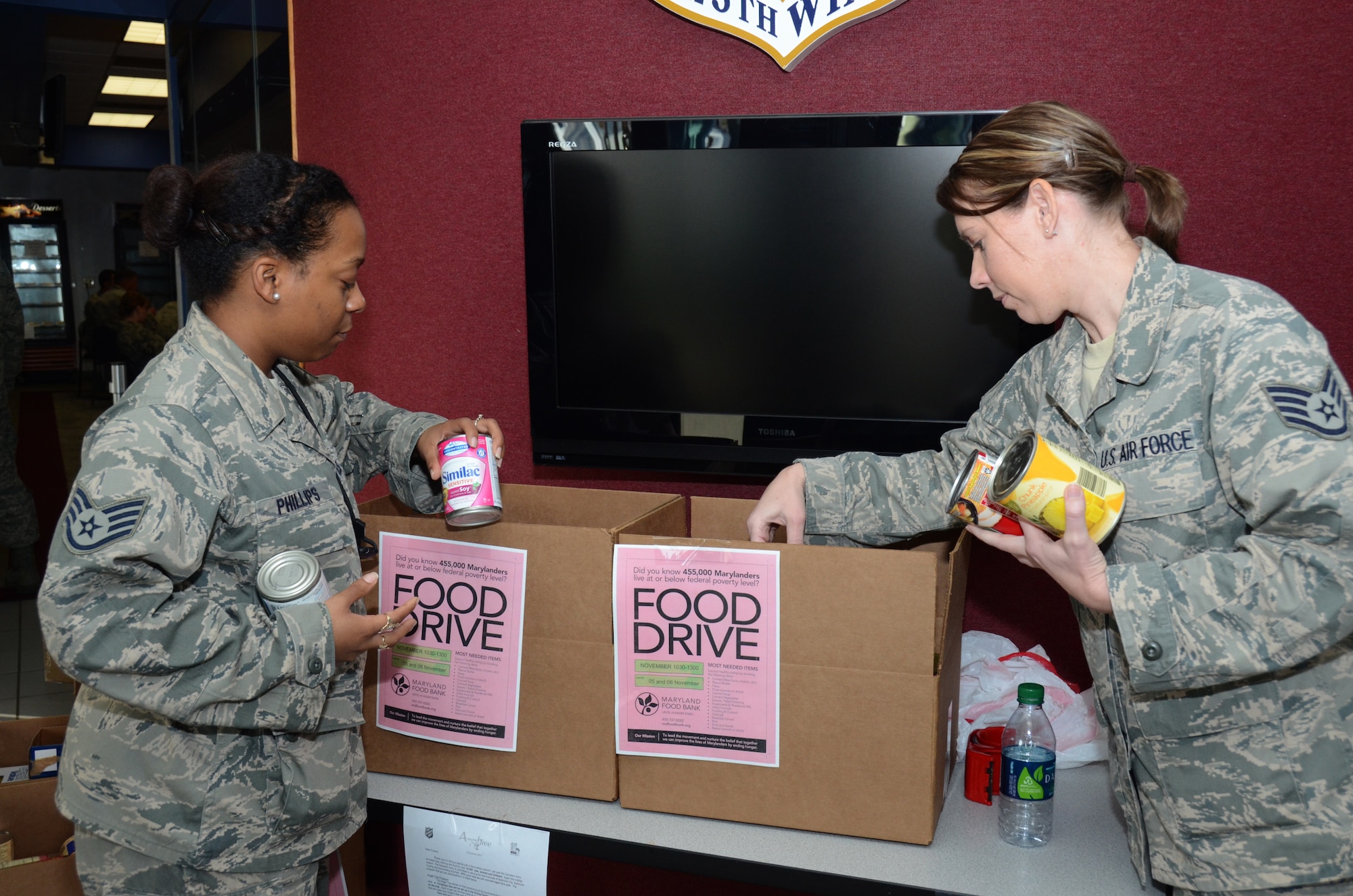 U.S. Air Force Staff Sgt. Adiah Phillips of the 175th Operations and Staff Sgt. Brenda Stewart, a public health technician with the 175th Medical Group, support the Maryland Food Bank by hosting a food drive on November 6, 2011 at Warfield Air National Guard Base, Baltimore, MD.  Members of the Maryland Air National Guard brought in non-perishable items like can goods, box rice, peanut butter, baby food, etc. (National Guard Photo By Staff Sgt. Benjamin Hughes/RELEASED)