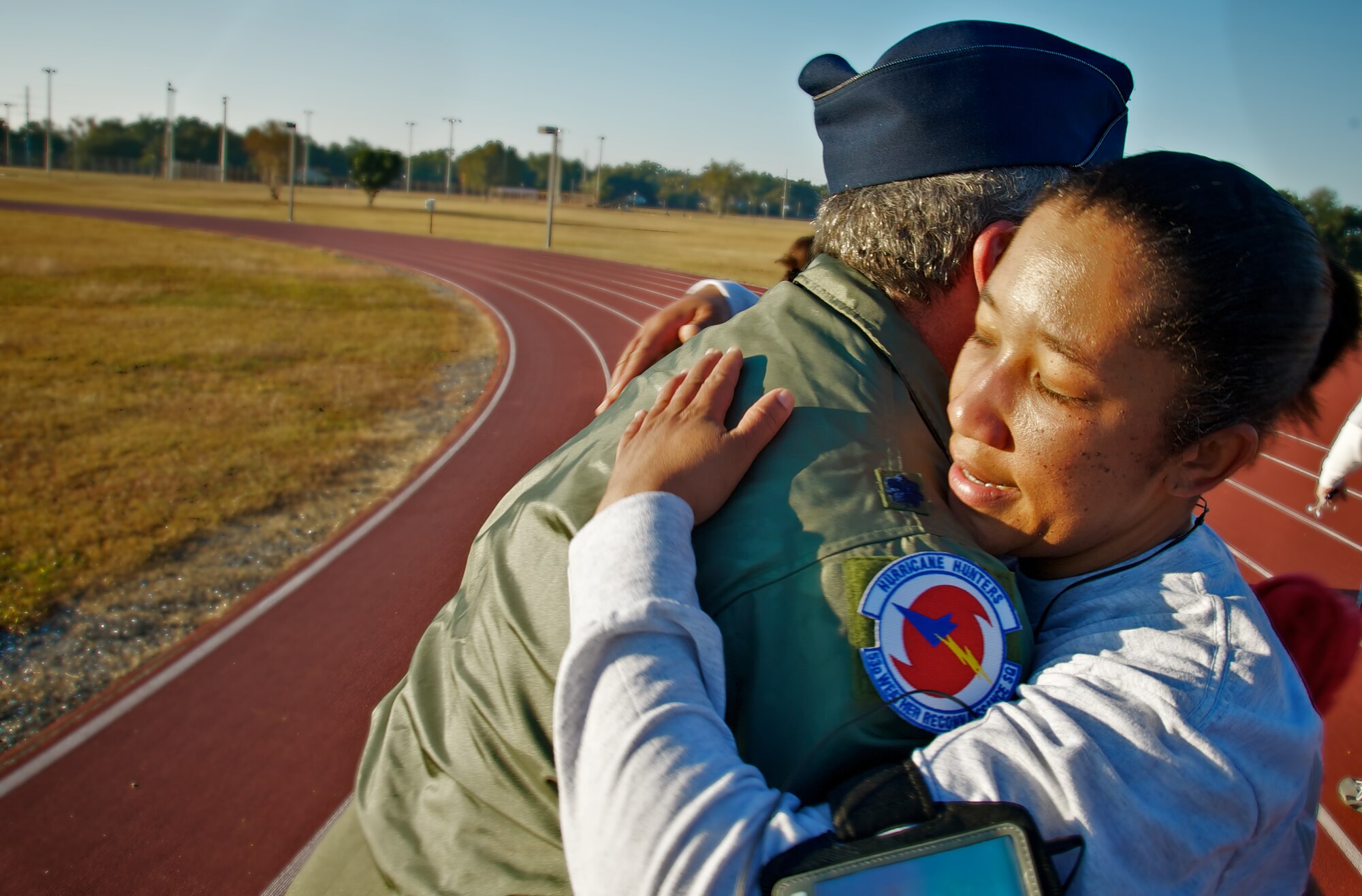 Master Sgt. Rachelle Johnson, 403rd Wing FSS, receives a congradulatory hug from Lt. Col. John Fox, the 403rd Wing Fitness Monitor,  after completing the 1.5 mile run. 
(U.S. Air Force photo by Capt. J. Justin Pearce)