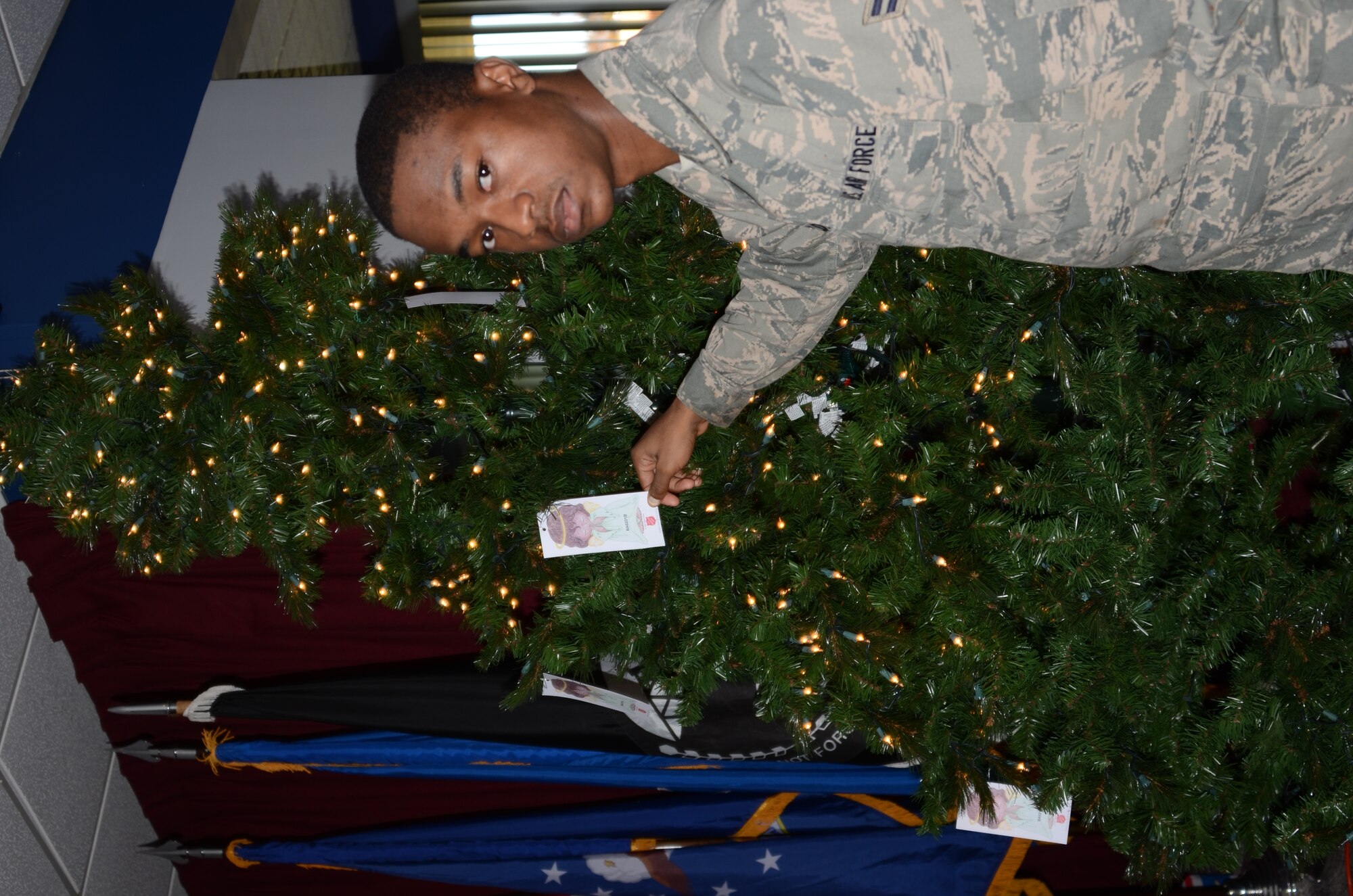 Airman 1st Class Qunicy Holder holds an angel from the Angel Tree program. Maryland Air National Guard members are supportoring less fortunate people in the Baltimore area with the Angel Tree program run by the Salvation Army. Airmen fill a wish list of clothing items and toys. (National Guard photo by Master Sgt. Ed Bard/Released)