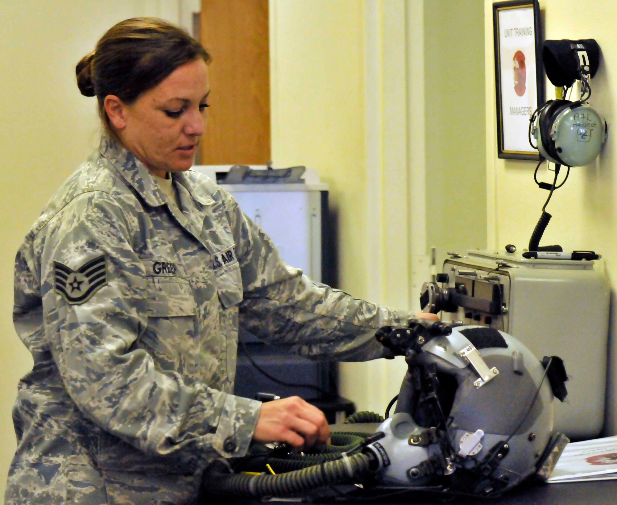 PATRICK AIR FORCE BASE, Fla. - Staff Sgt. Stacie Greer, aircrew flight equipment specialist, runs an operational check on a pilot's helmet following the Cocoa Beach Air Show Nov 5-6. AFE specialists not only run checks on all equipment before and after flights during the air show, but they assist visiting pilots performing in the air show. (U.S. Air Force Photo/Capt. Ryan Liss)